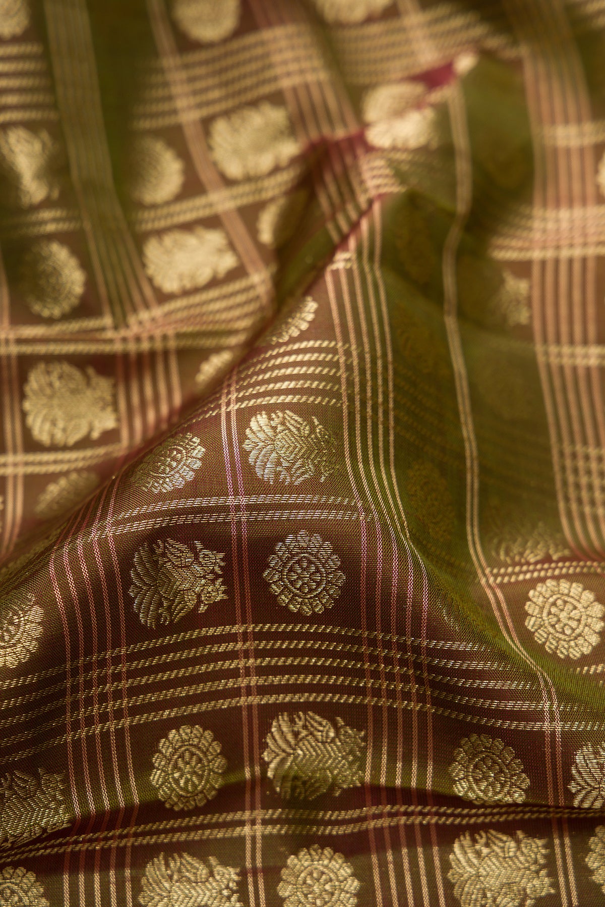 Close up of Pure Silk Mehandi Green Kanchipuram Saree with Zari Brocade on the body and Fancy Border.  displaying folds