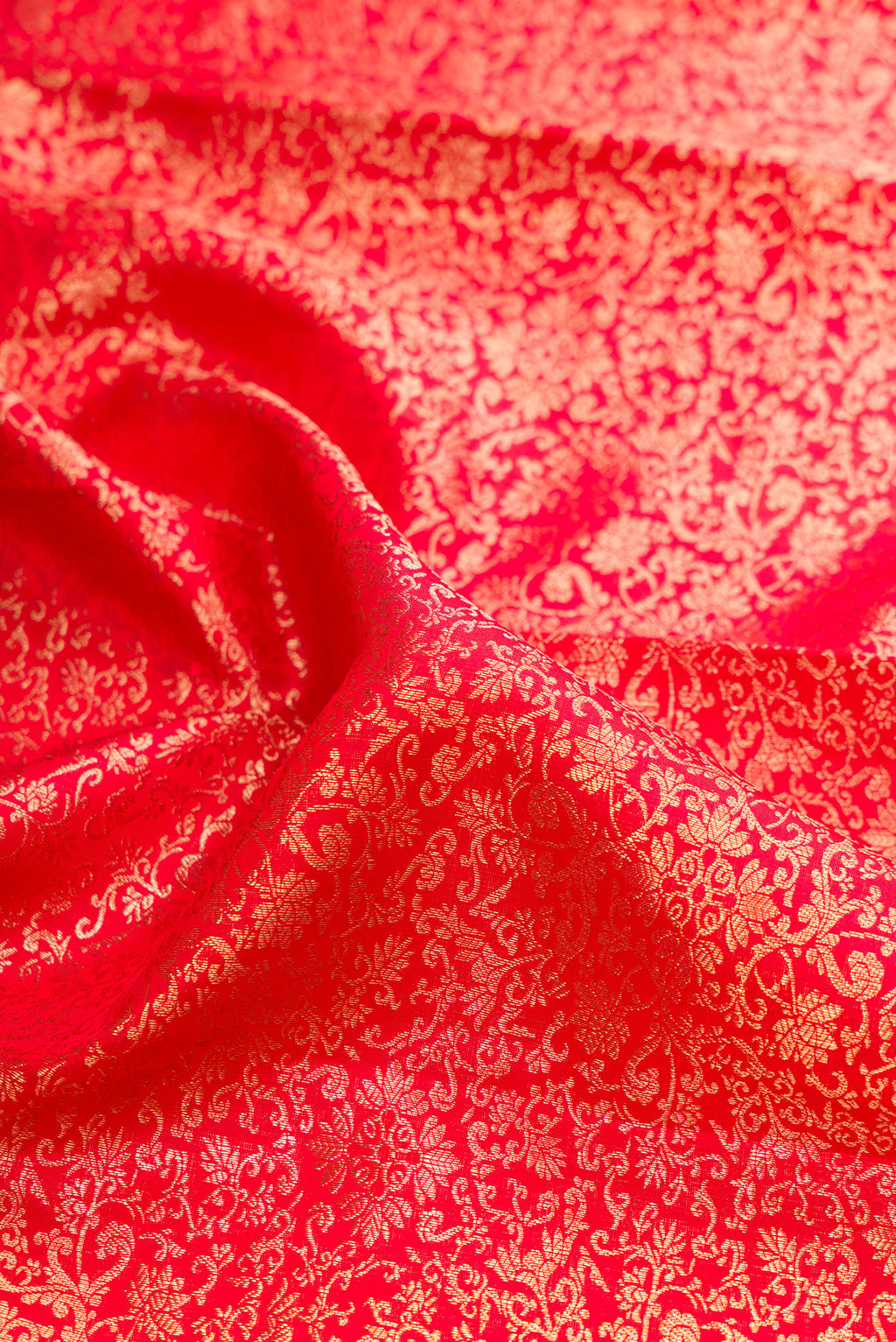 Close up of Pure Silk Red Dual Tone Kanchipuram Saree with Zari Brocade on the body and Zari Border.  displaying folds