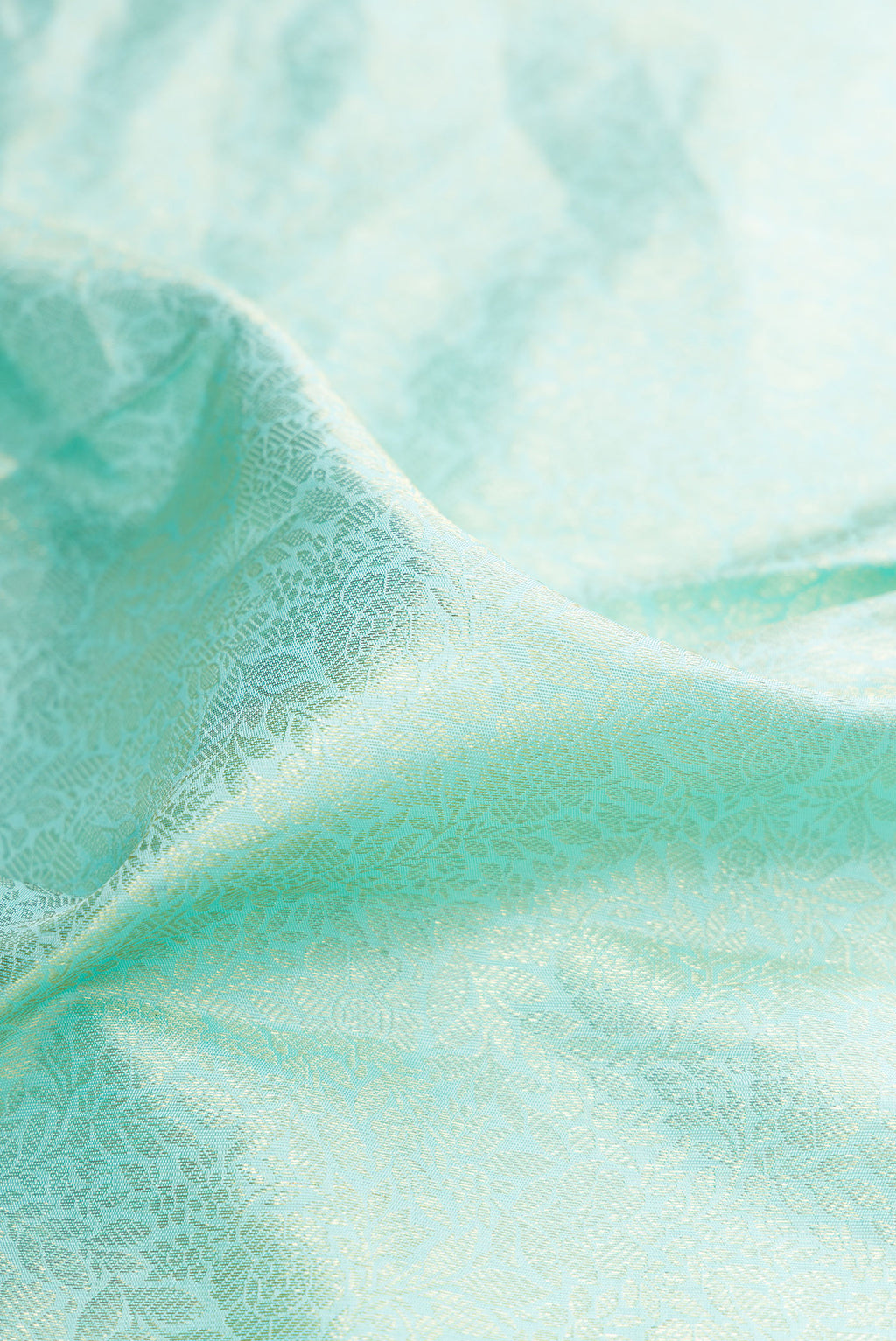 Close up of Pure Silk Light Blue Dual Tone Kanchipuram Saree with Zari Brocade on the body and Zari Border.  displaying folds