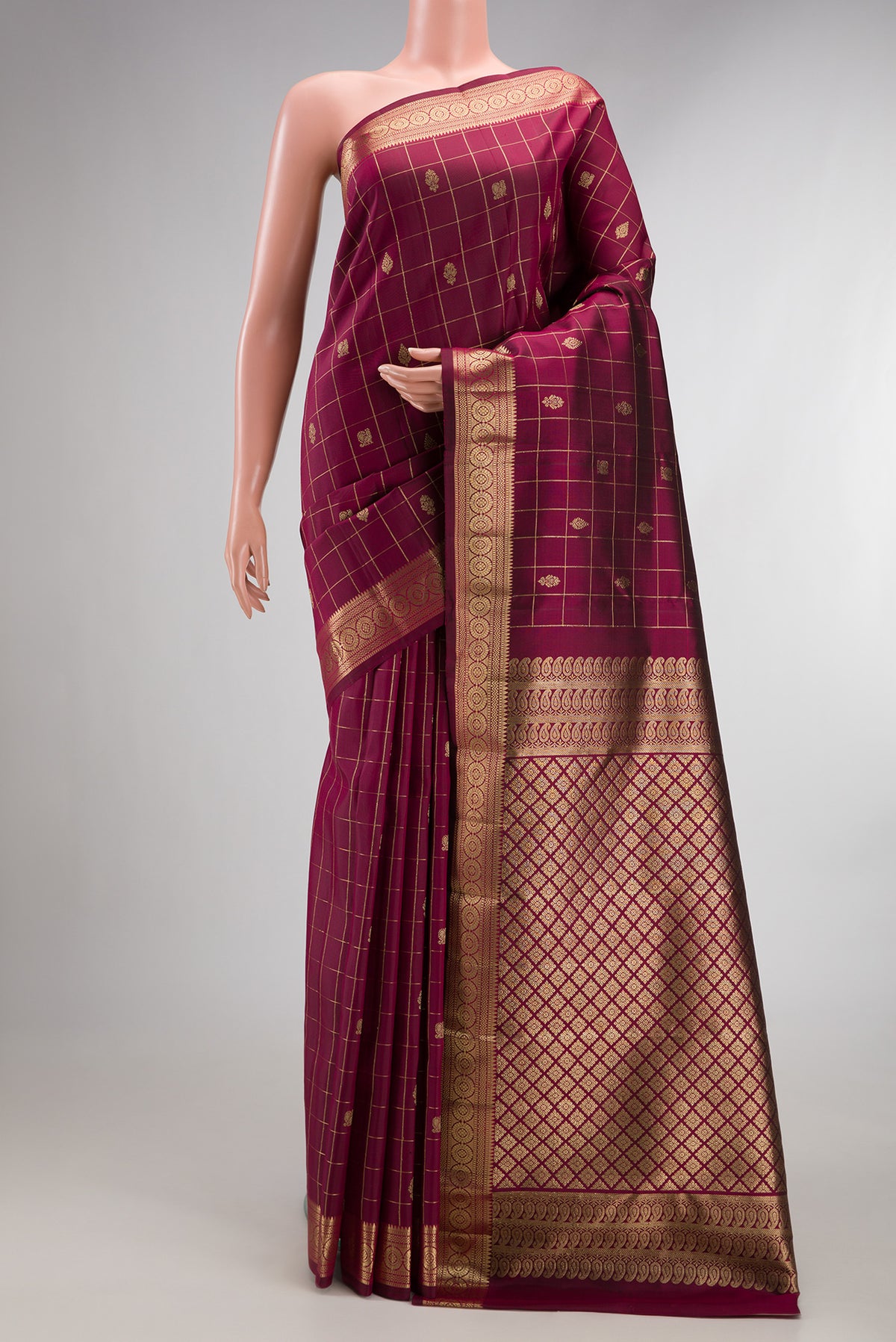 Pure Silk Maroon Kanchipuram Saree with Checked design on the body and Zari Border.  displayed on a mannequin
