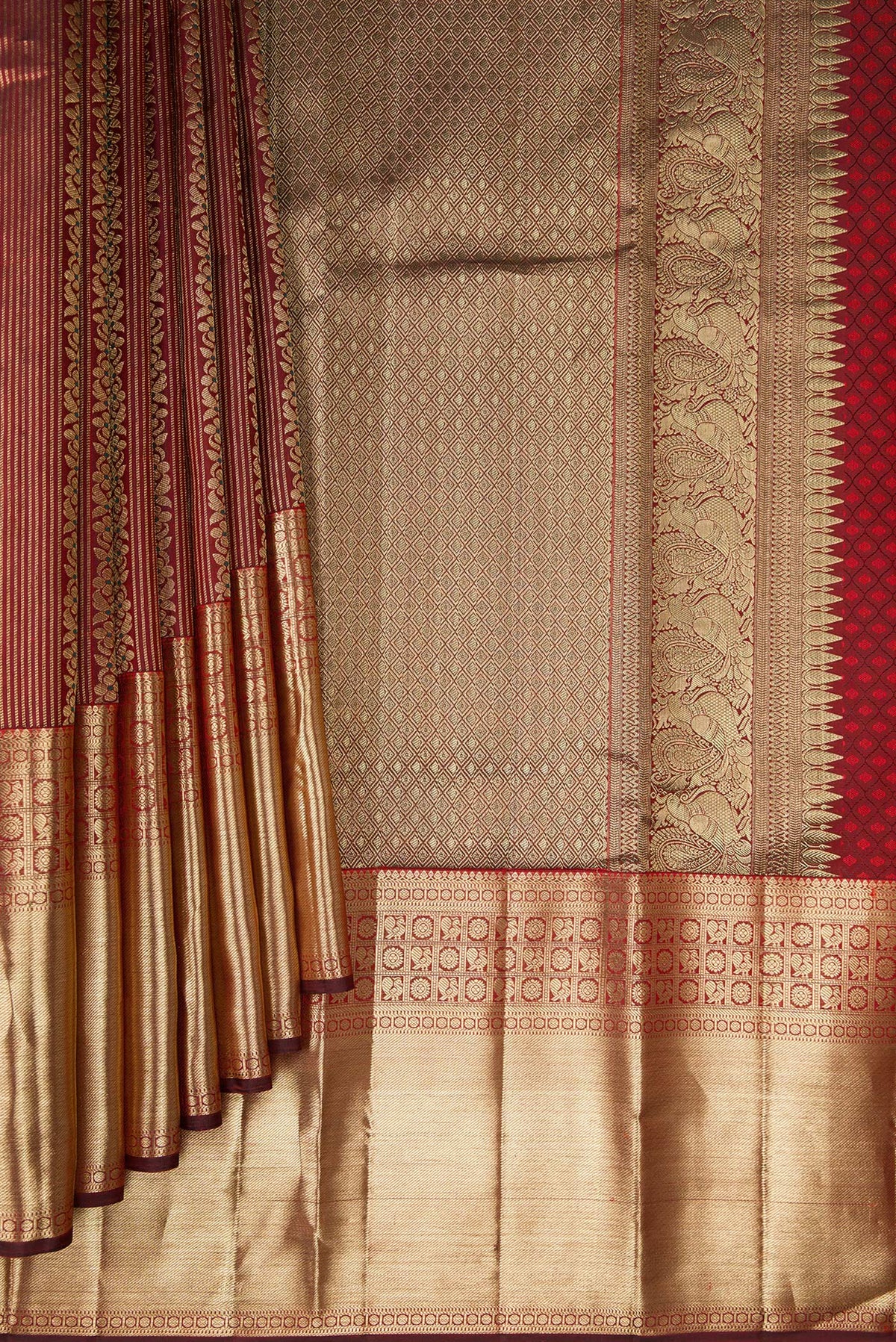 Pleats and pallu of Pure Silk Maroon Dual Tone Kanchipuram Saree with Zari Brocade on the body and Fancy Border. 