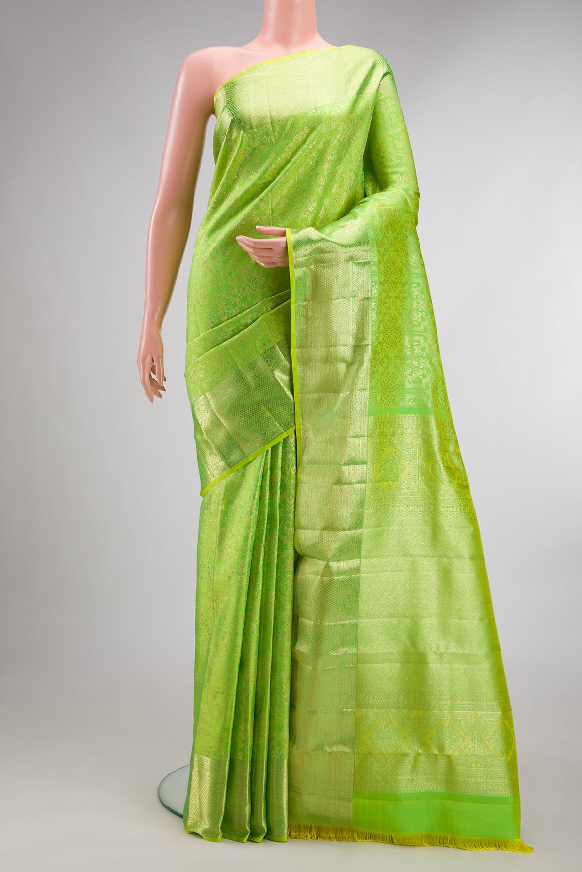 Pure Silk Parrot Green Kanchipuram Saree with Zari Brocade on the body and Fancy Border.  displayed on a mannequin