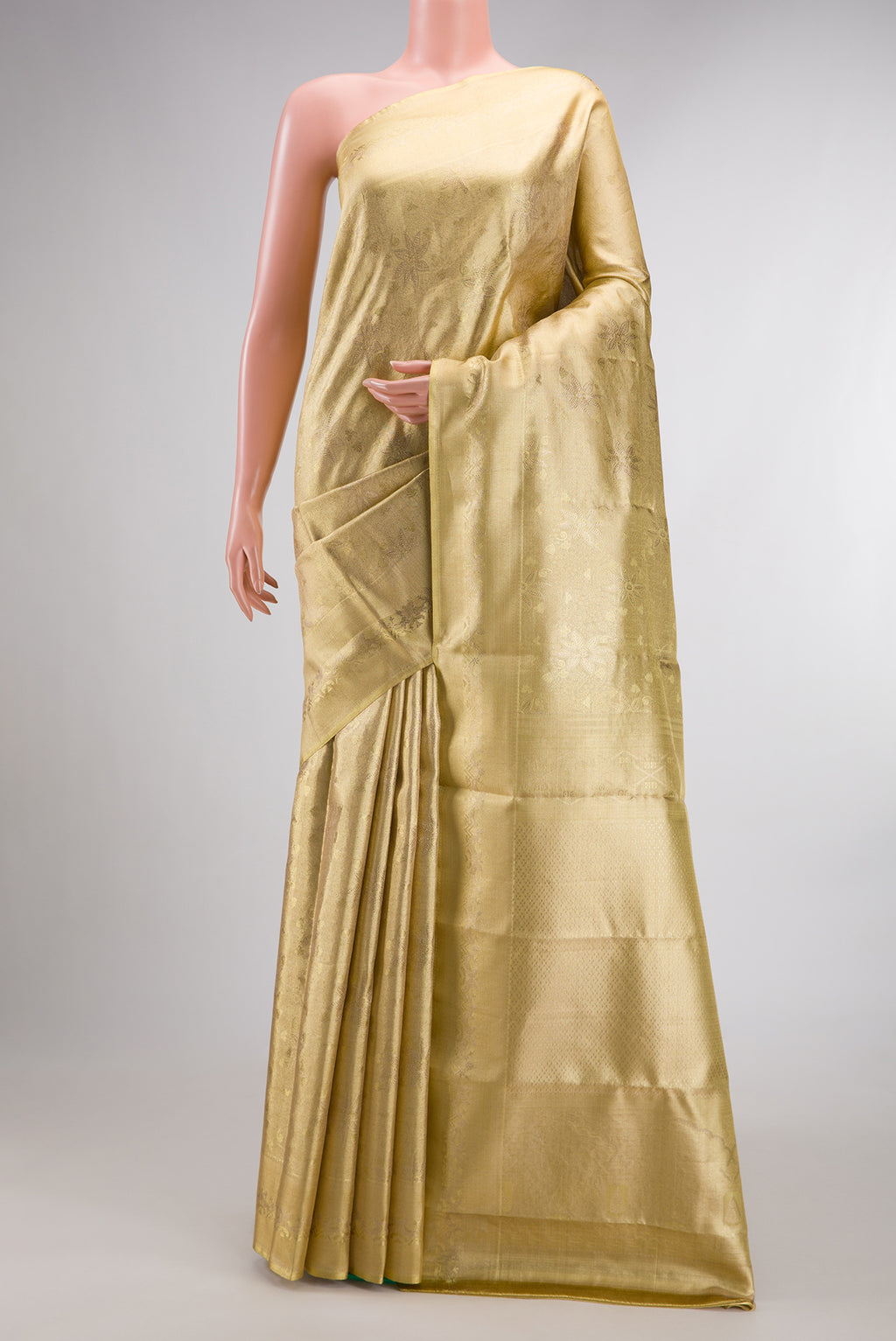 Gold with Red Dual Tone Kanjivaram Tissue Saree with Zari Brocade on the body and Fancy Border.  displayed on a mannequin