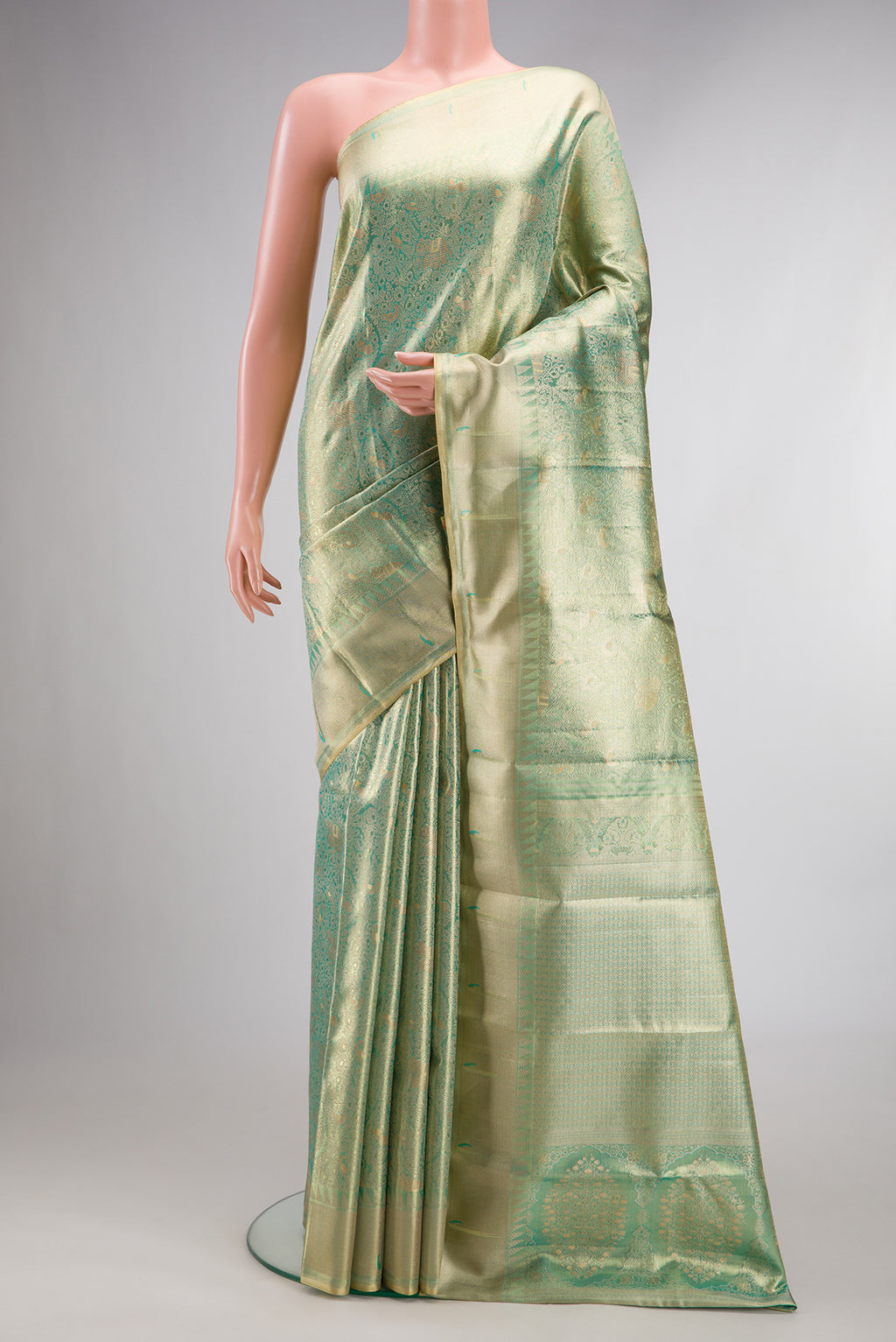 Pista Green Dual Tone Kanjivaram Tissue Saree with Zari Brocade on the body and Fancy Border.  displayed on a mannequin