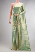 Pista Green Dual Tone Kanjivaram Tissue Saree with Zari Brocade on the body and Fancy Border.  displayed on a mannequin