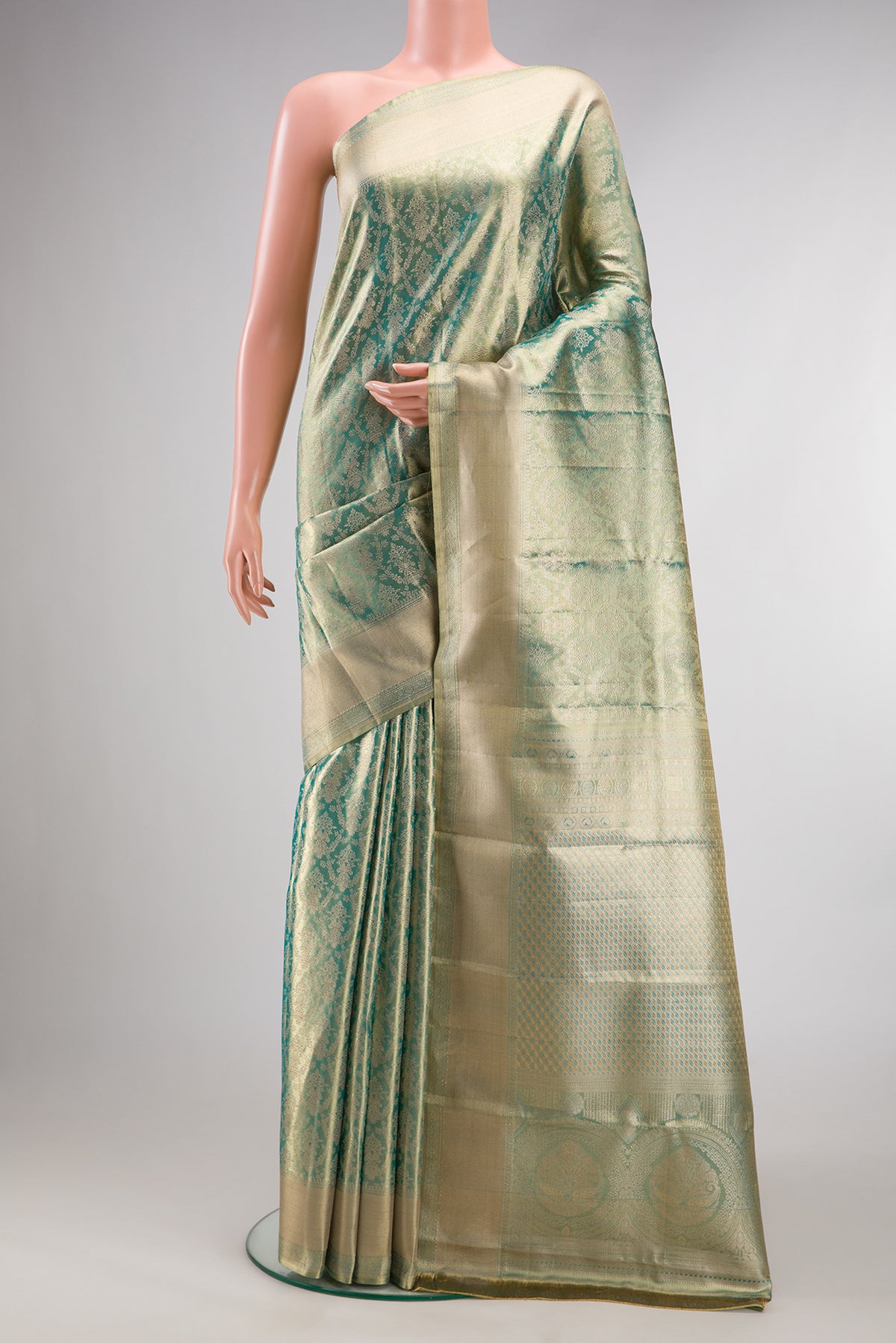 Light Green Dual Tone Kanjivaram Tissue Saree with Zari Brocade on the body and Fancy Border.  displayed on a mannequin