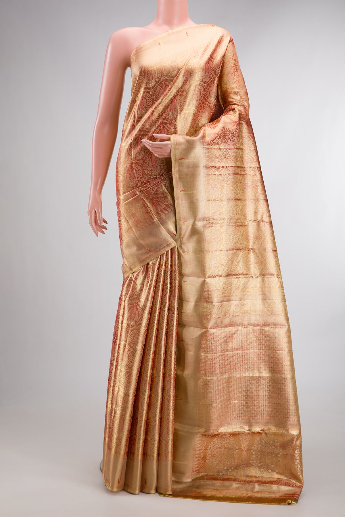 Gold with Red Color Kanjivaram Tissue Saree with Zari Brocade on the body and Paithani Border.  displayed on a mannequin