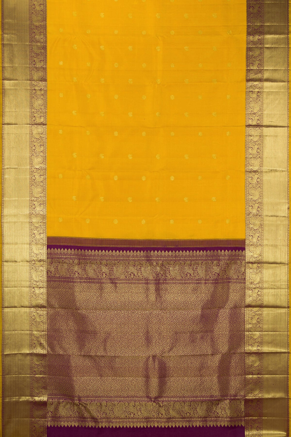 Flat view of Pure Silk Mustard Kanjivaram Saree with Zari Butta on the body and Zari Border. 