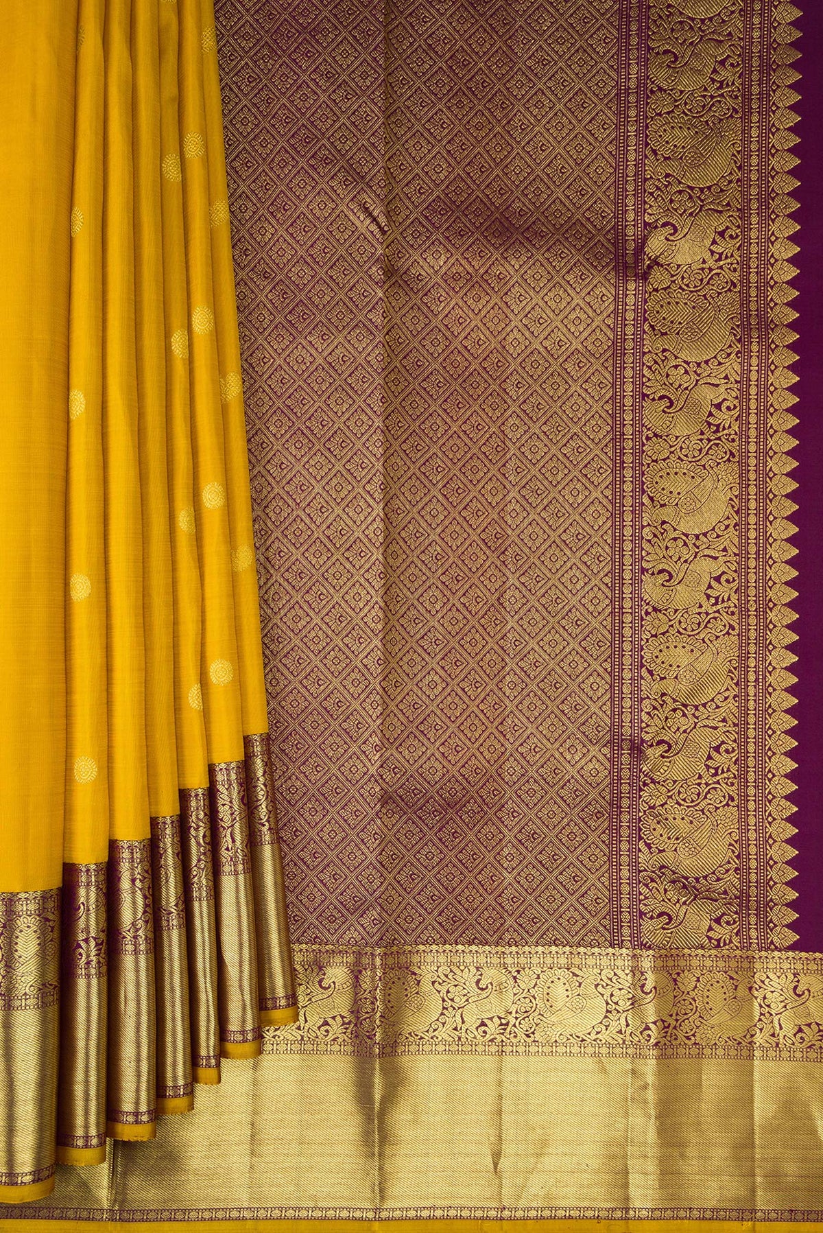 Pleats and pallu of Pure Silk Mustard Kanjivaram Saree with Zari Butta on the body and Zari Border. 