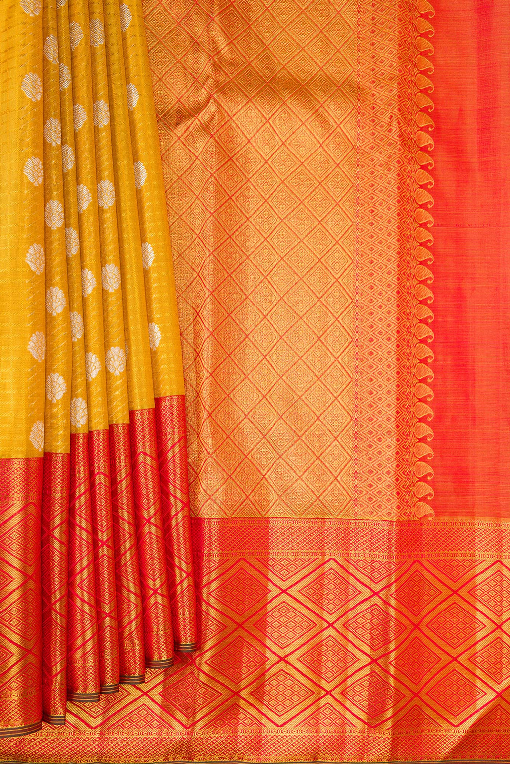 Pleats and pallu of Mustard Kanchipuram Tissue Saree with Zari Brocade on the body and Fancy Border. 