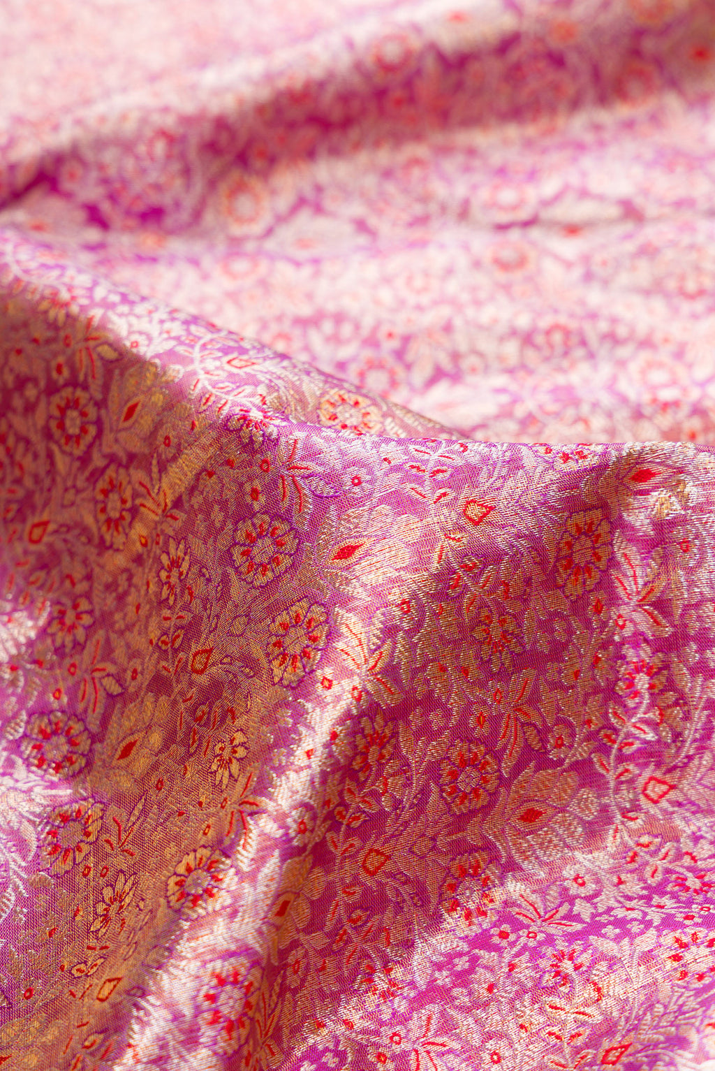 Close up of Pure Silk Pure Zari Purple Dual Tone Kanchipuram Tissue Saree with Zari Brocade on the body and Zari Border.  displaying folds
