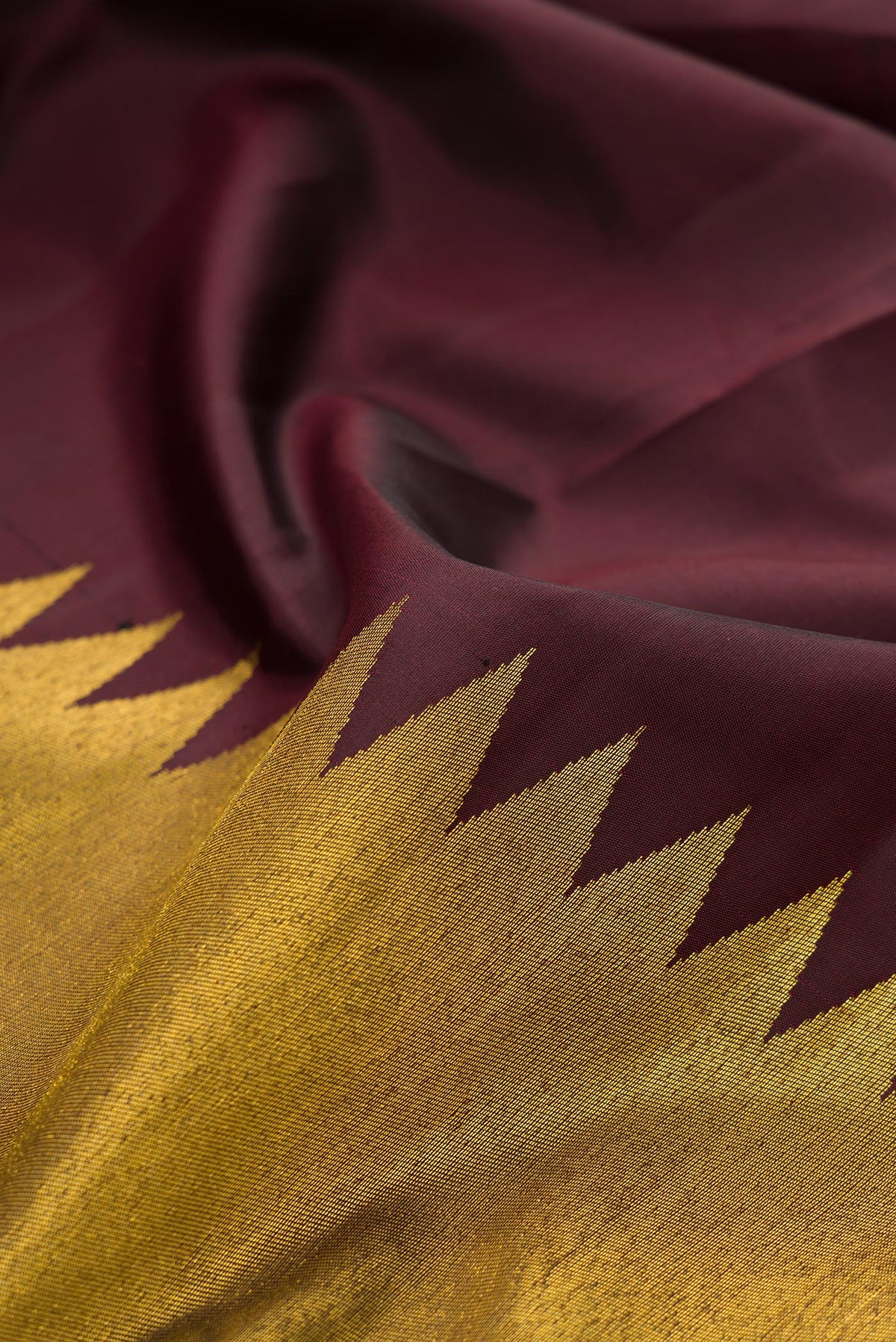 Close up of Pure Silk Coffee Brown Dual Tone Kanjivaram Saree with Plain Body and Rising Temple Border.  displaying folds