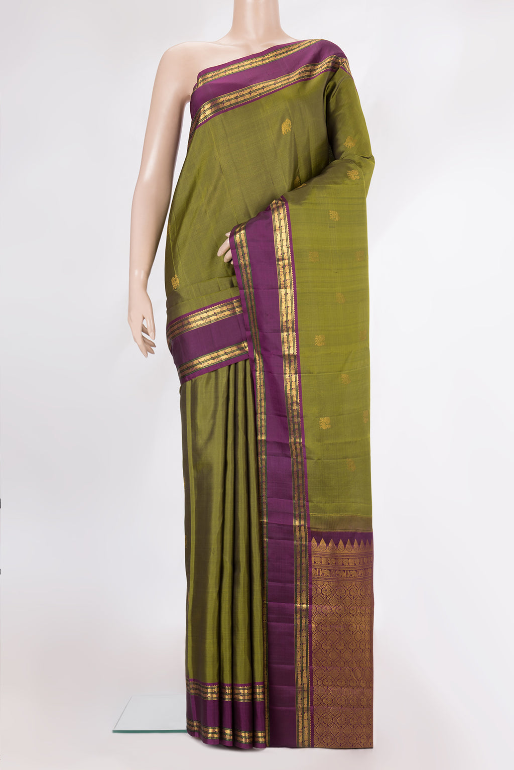 Pure Silk Mehandi Green Kanjivaram Saree with Zari Butta on the body and Zari Border.  displayed on a mannequin