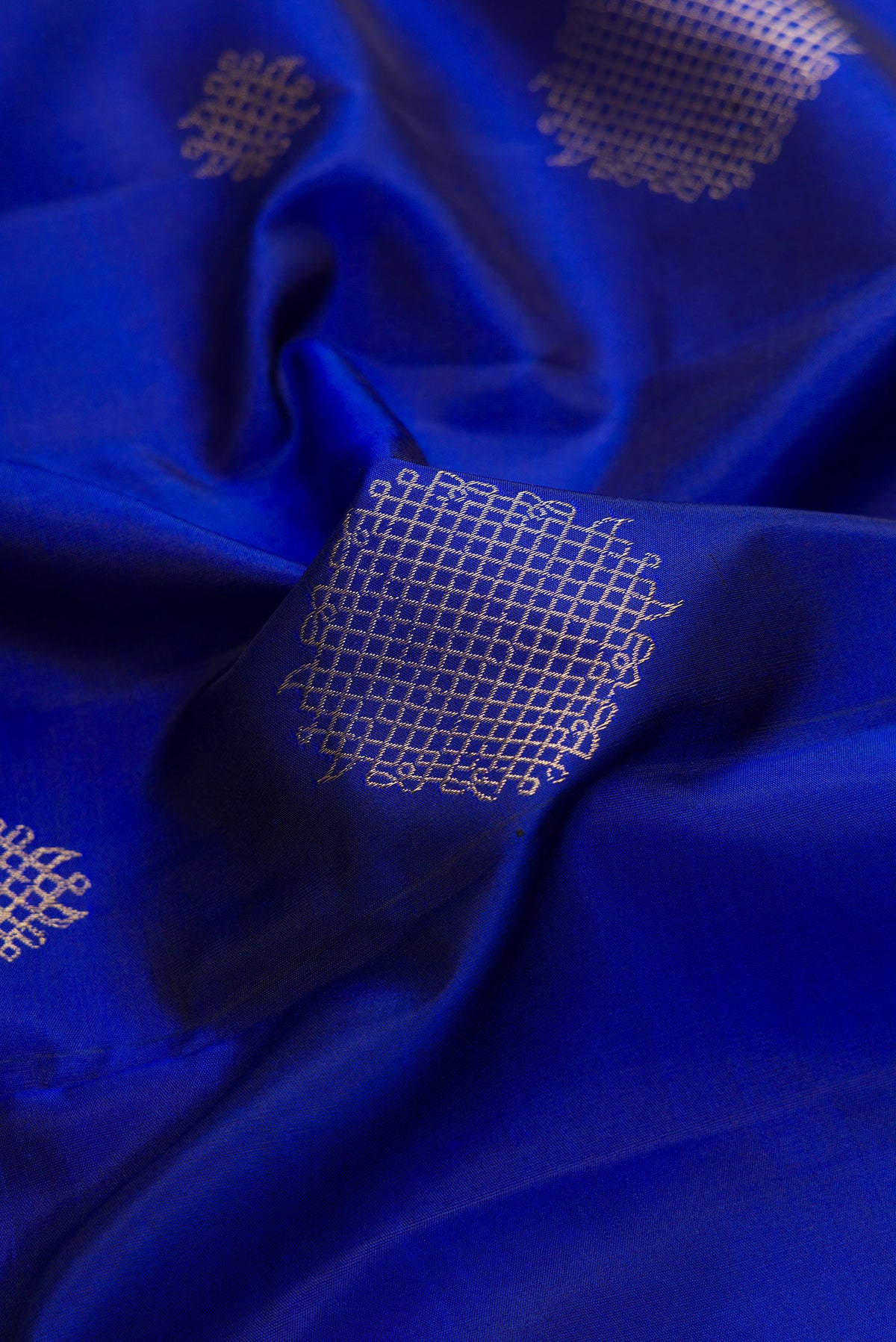 Close up of Pure Silk Royal Blue Kanchipuram Saree with Zari Butta on the body and Thin Zari Line.  displaying folds