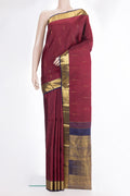 Pure Silk Maroon Kanjivaram Saree with Zari Butta on the body and Zari Border.  displayed on a mannequin
