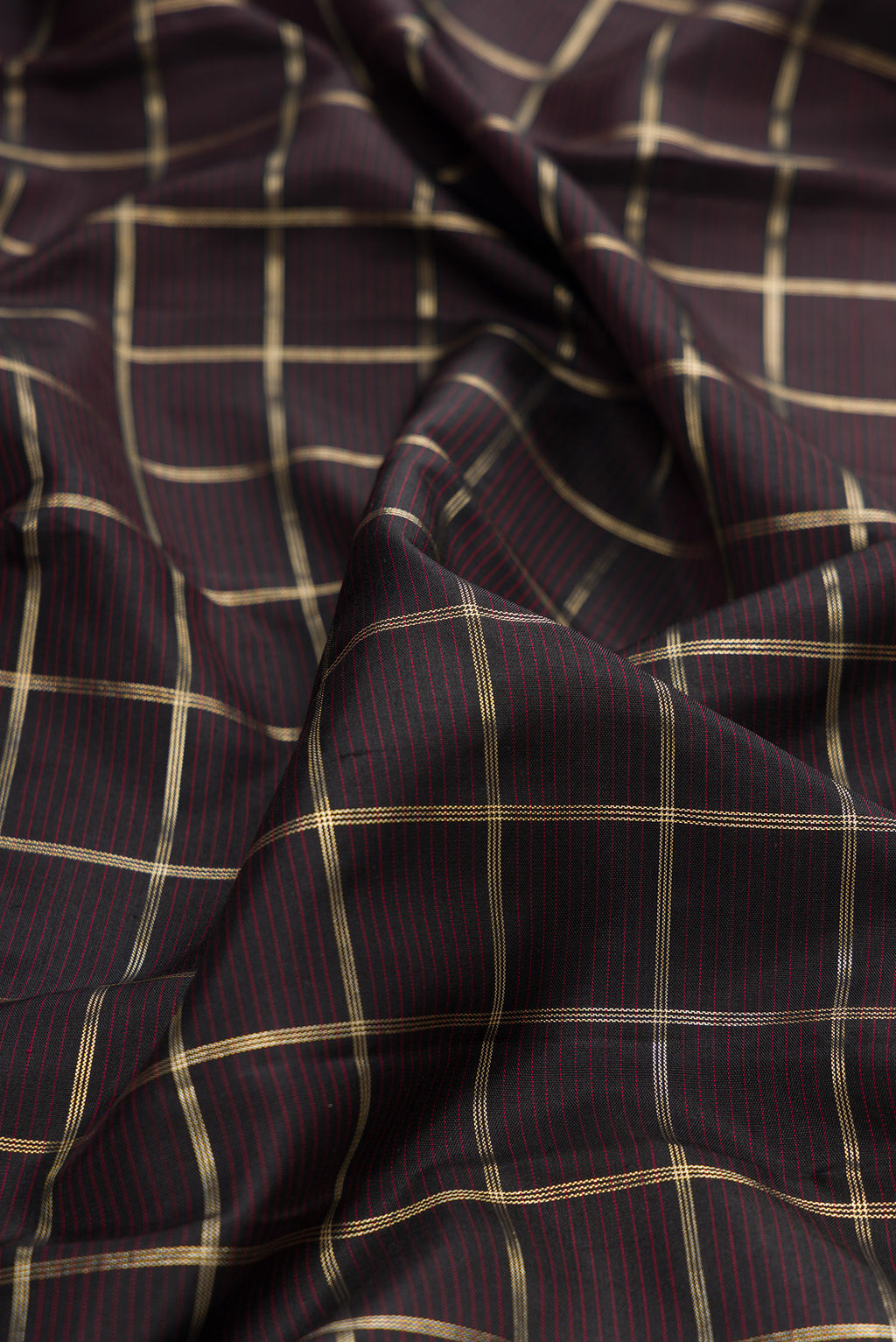Close up of Pure Silk Coffee Brown Kanjivaram Saree with Checked design on the body and Zari Border.  displaying folds