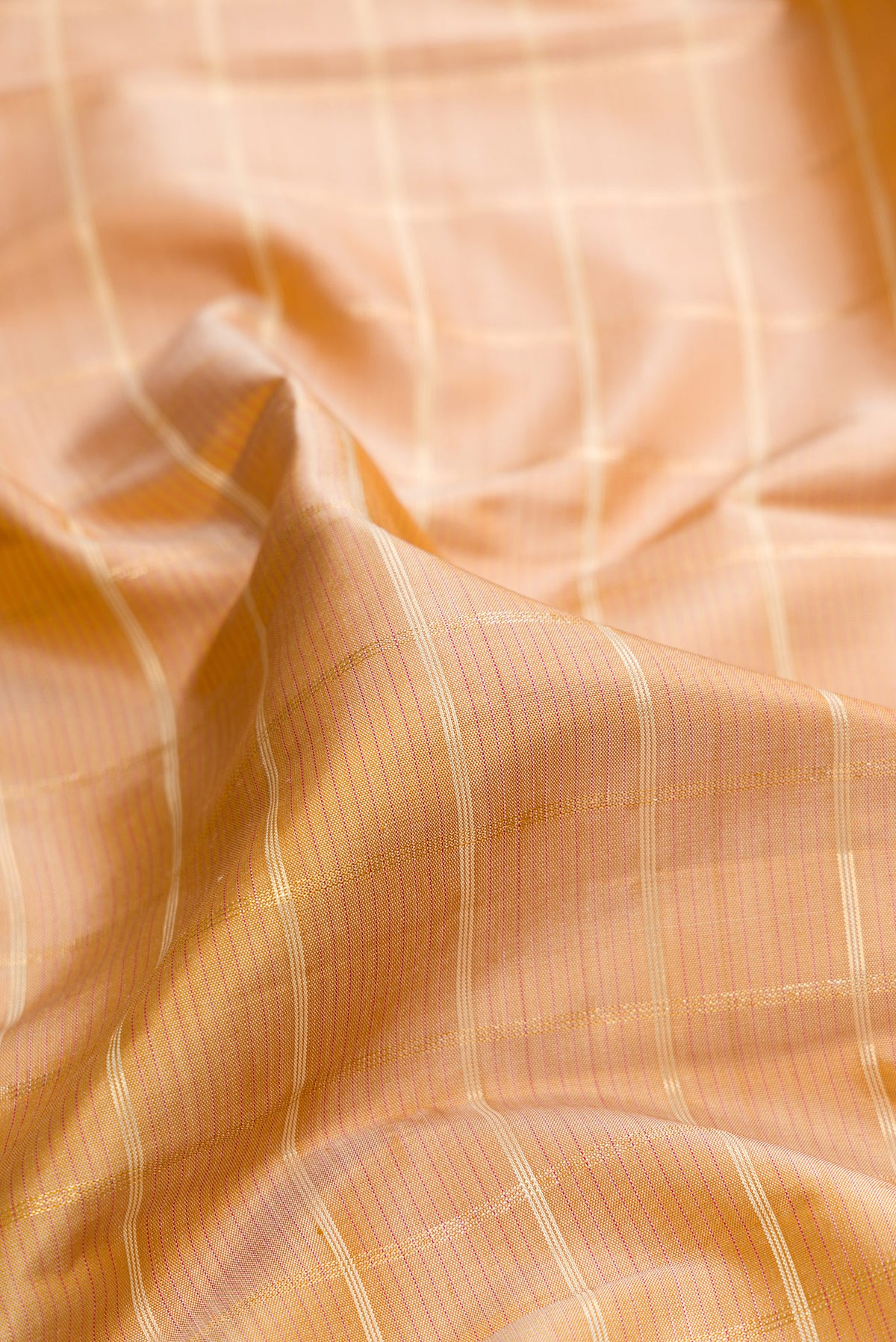 Close up of Pure Silk Sandal Kanjivaram Saree with Checked design on the body and Zari Border.  displaying folds