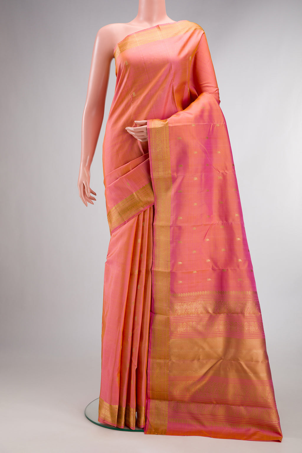 Pure Silk Pinkish Yellow Dual Tone Kanjivaram Saree with Thread Butta on the body and Thread Border.  displayed on a mannequin