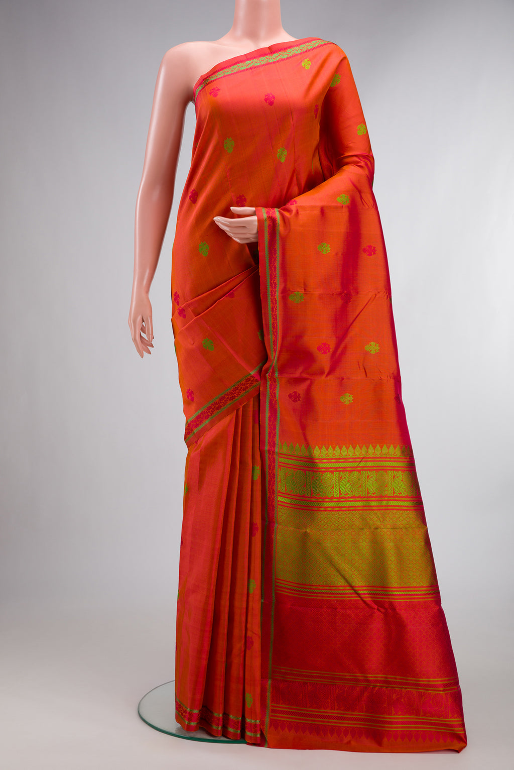 Pure Silk Orange Kanchipuram Saree with Thread Butta on the body and Thread Border.  displayed on a mannequin