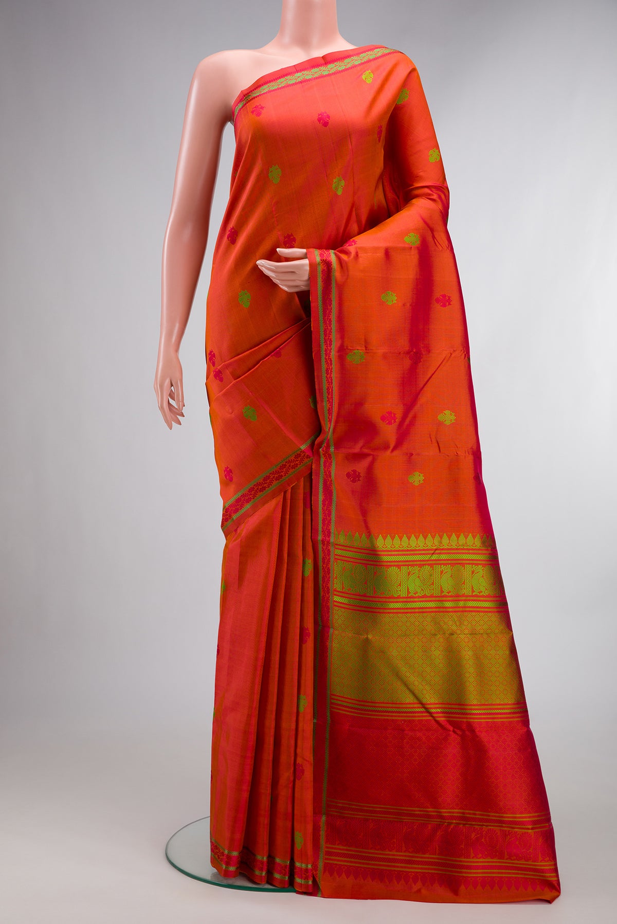 Pure Silk Orange Kanchipuram Saree with Thread Butta on the body and Thread Border.  displayed on a mannequin