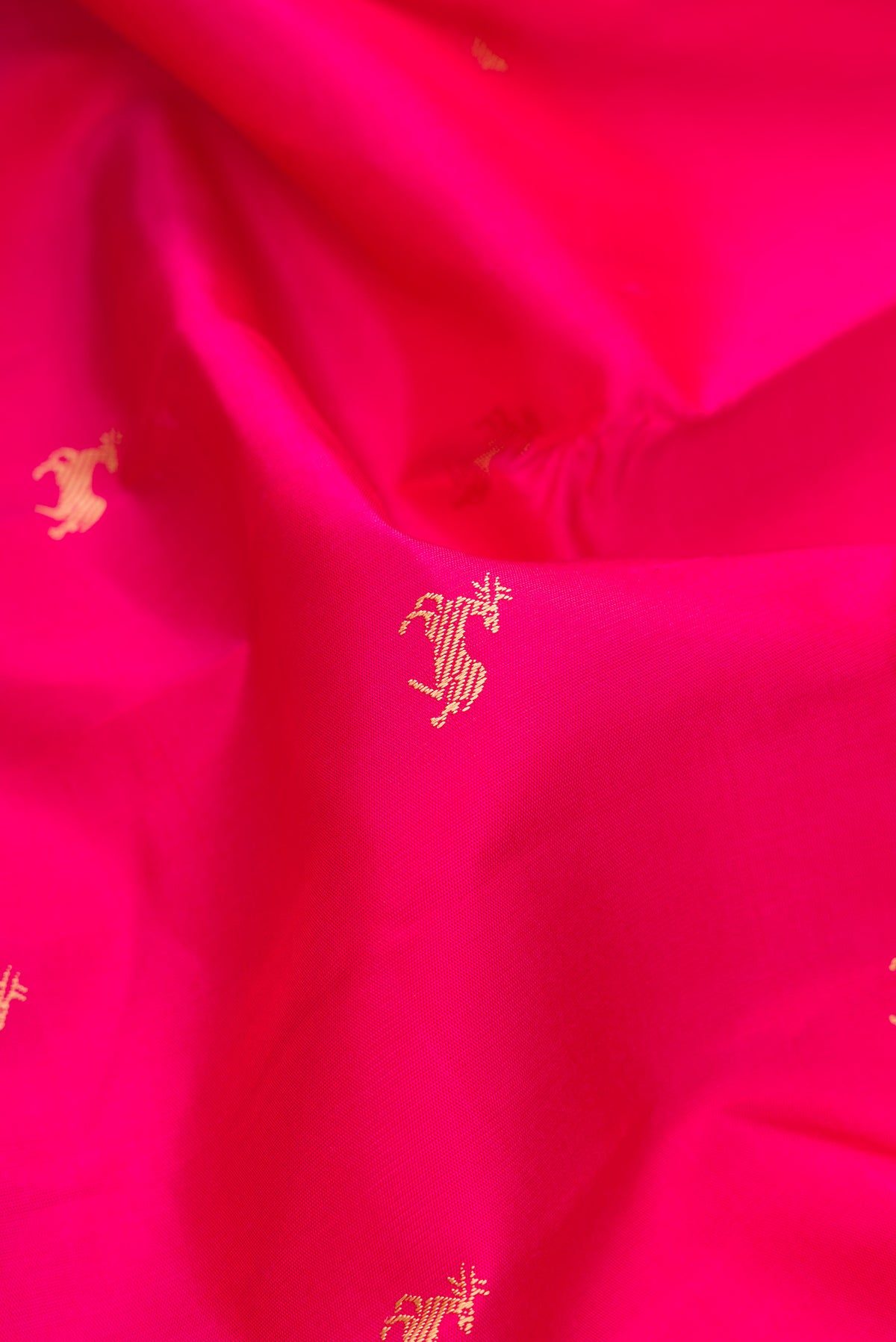 Close up of Pure Silk Pink Kanchipuram Saree with Thread Butta on the body and Thread Border.  displaying folds