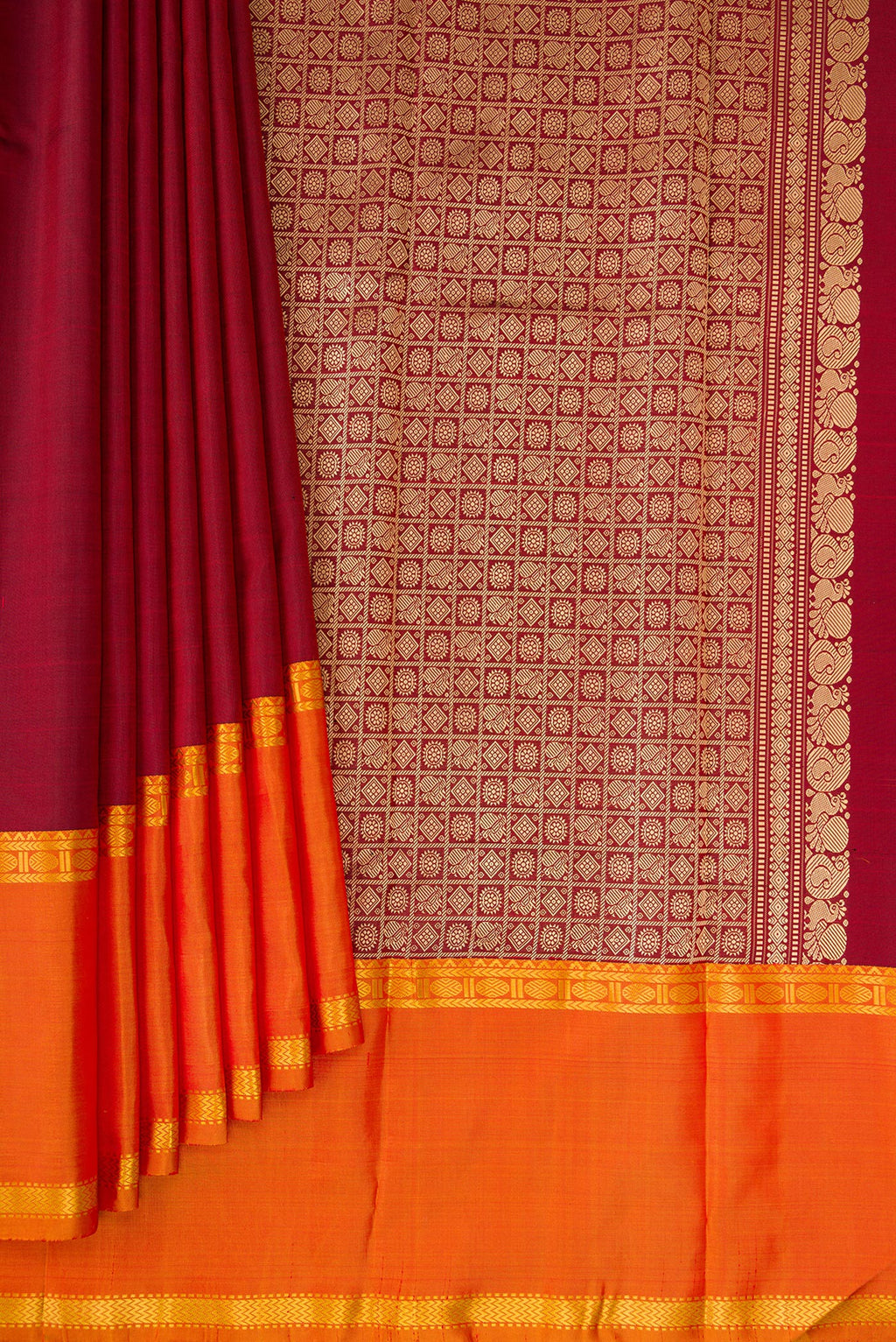 Pleats and pallu of Pure Silk Maroon Kanchipuram Saree with Plain Body and Ganga Jamuna Border. 
