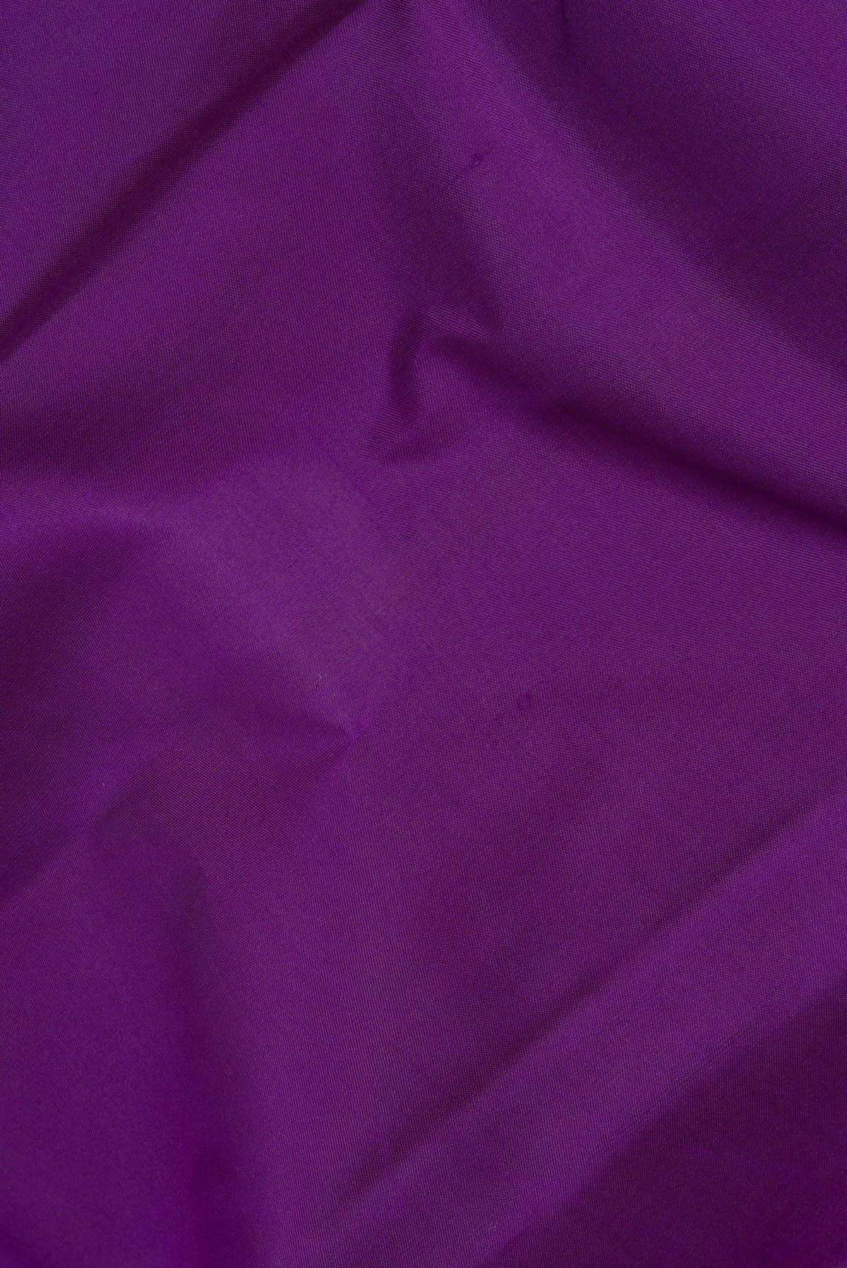 Close up of Pure Silk Purple Kanchipuram Saree with Plain Body and Zari Border.  displaying folds