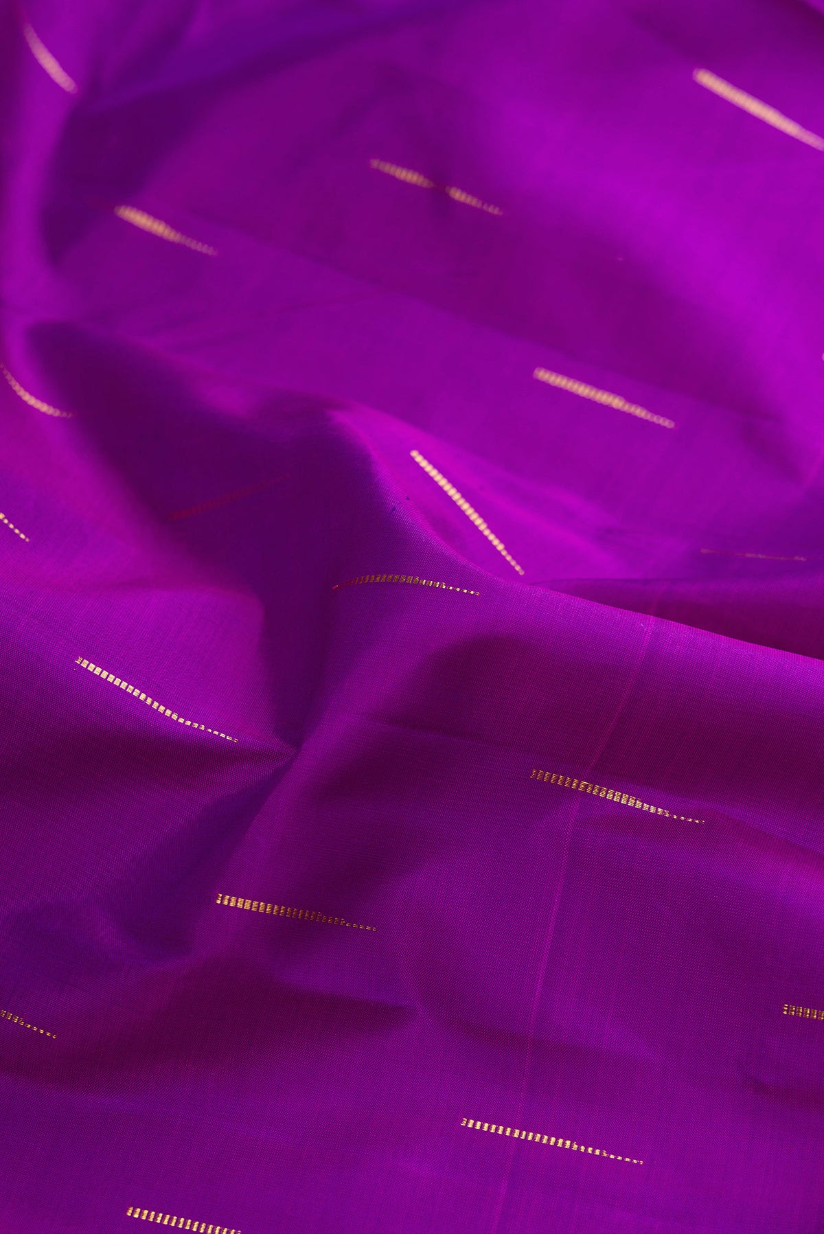 Close up of Pure Silk Purple Kanchipuram Saree with Zari Butta on the body and Zari Border.  displaying folds