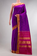 Pure Silk Purple Kanchipuram Saree with Zari Butta on the body and Zari Border.  displayed on a mannequin