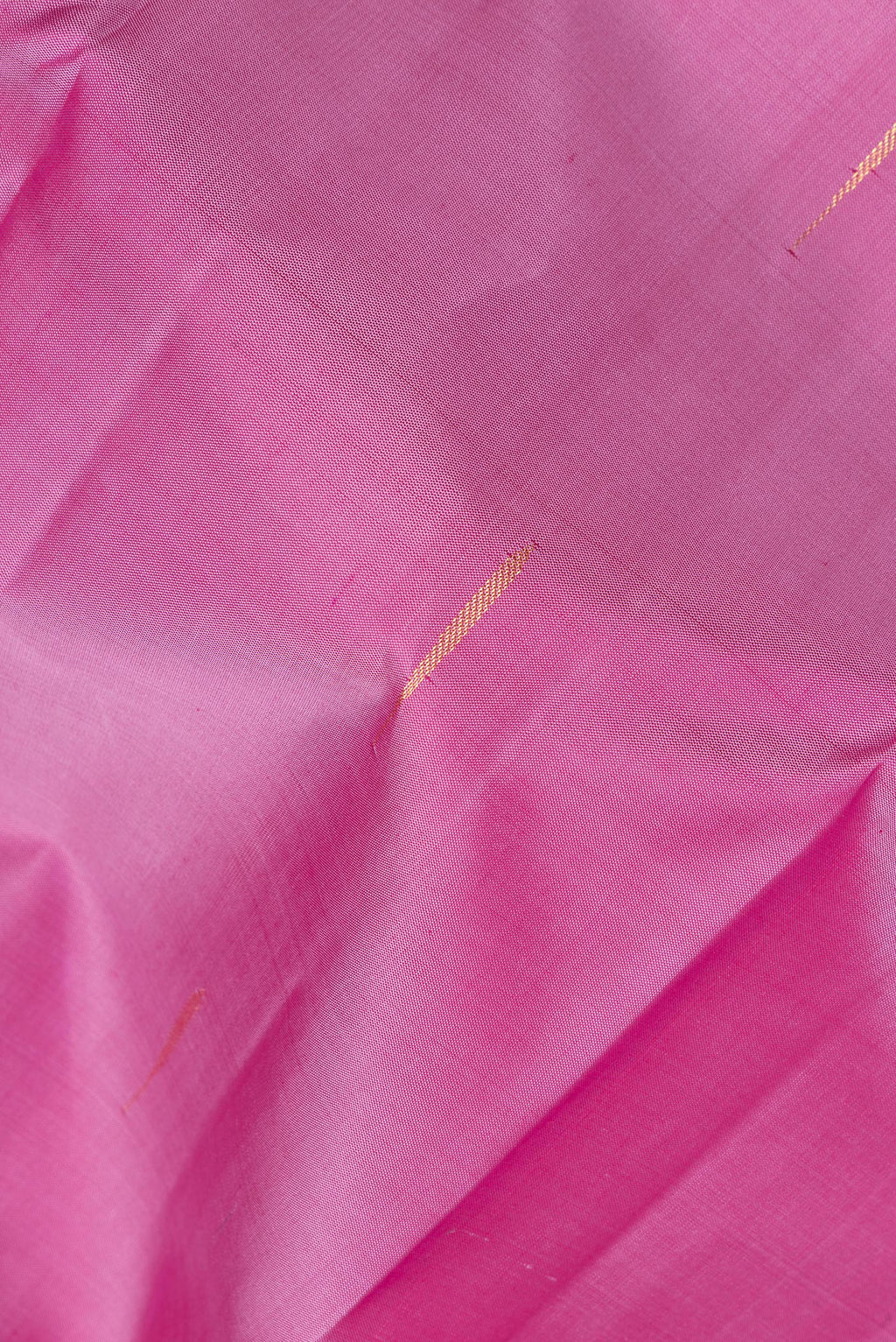 Close up of Pure Silk Pink Dual Tone Kanchipuram Saree with Zari Butta on the body and Zari Border.  displaying folds