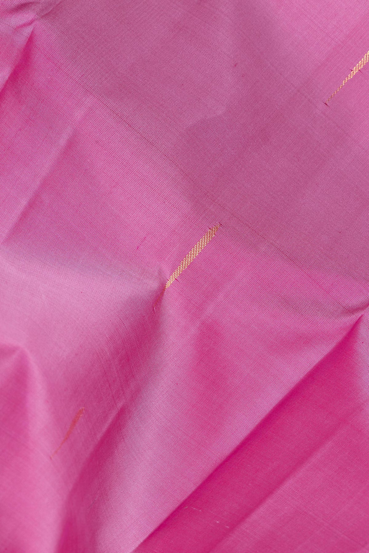 Close up of Pure Silk Pink Dual Tone Kanchipuram Saree with Zari Butta on the body and Zari Border.  displaying folds