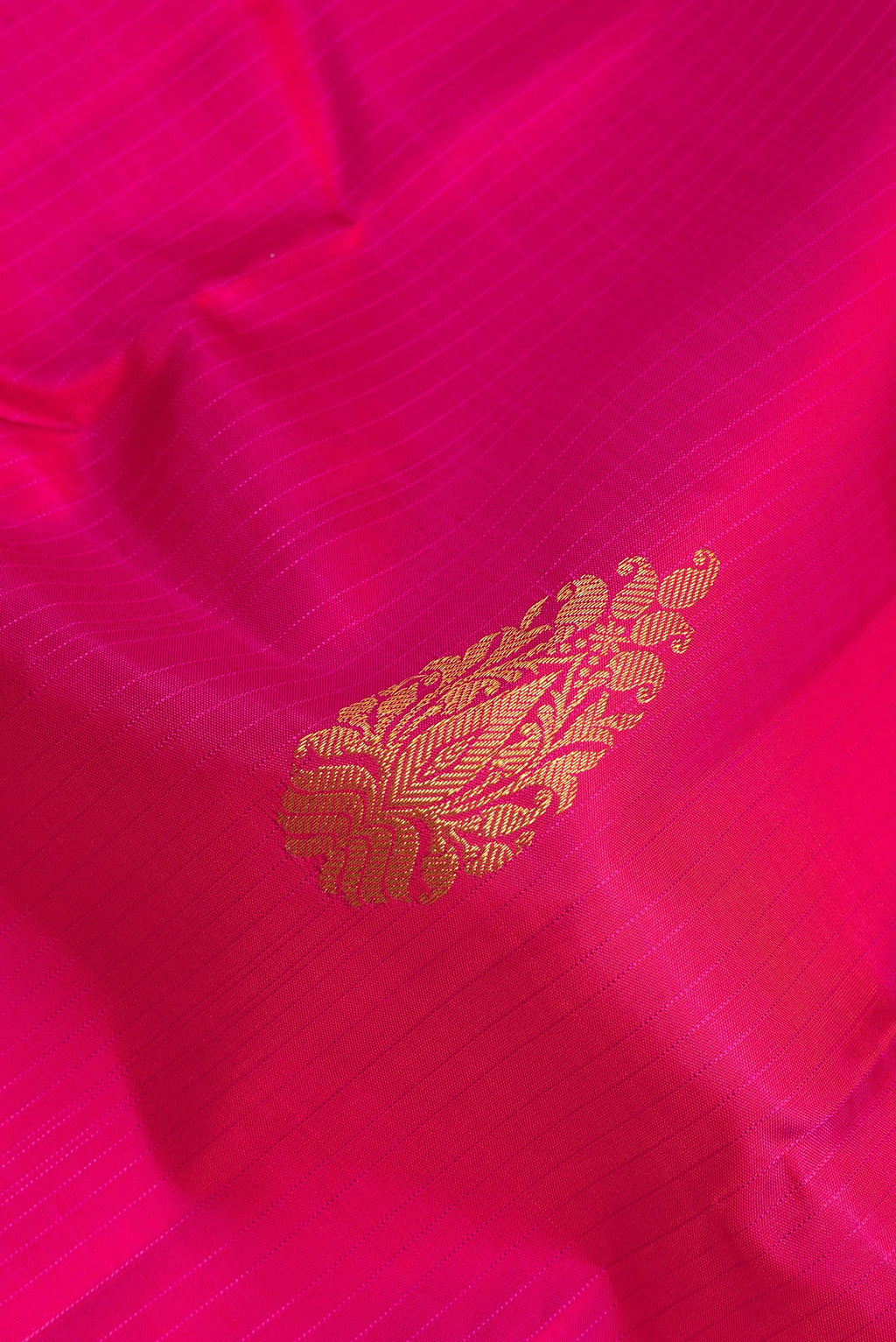 Close up of Pure Silk Dark Pink Kanchipuram Saree with Zari Butta on the body and Without Border.  displaying folds