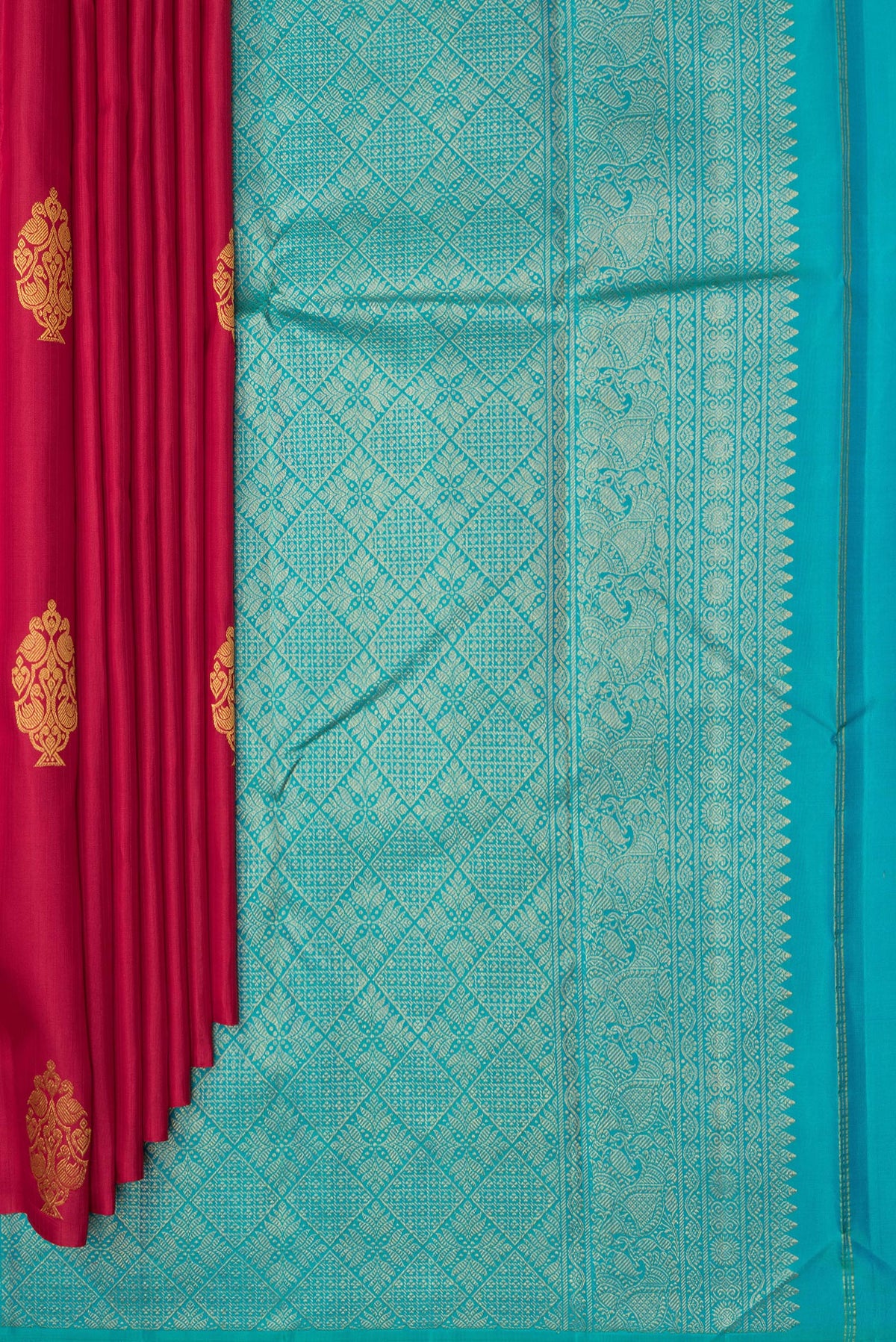 Pleats and pallu of Pure Silk Red Kanchipuram Saree with Zari Butta on the body and Without Border. 