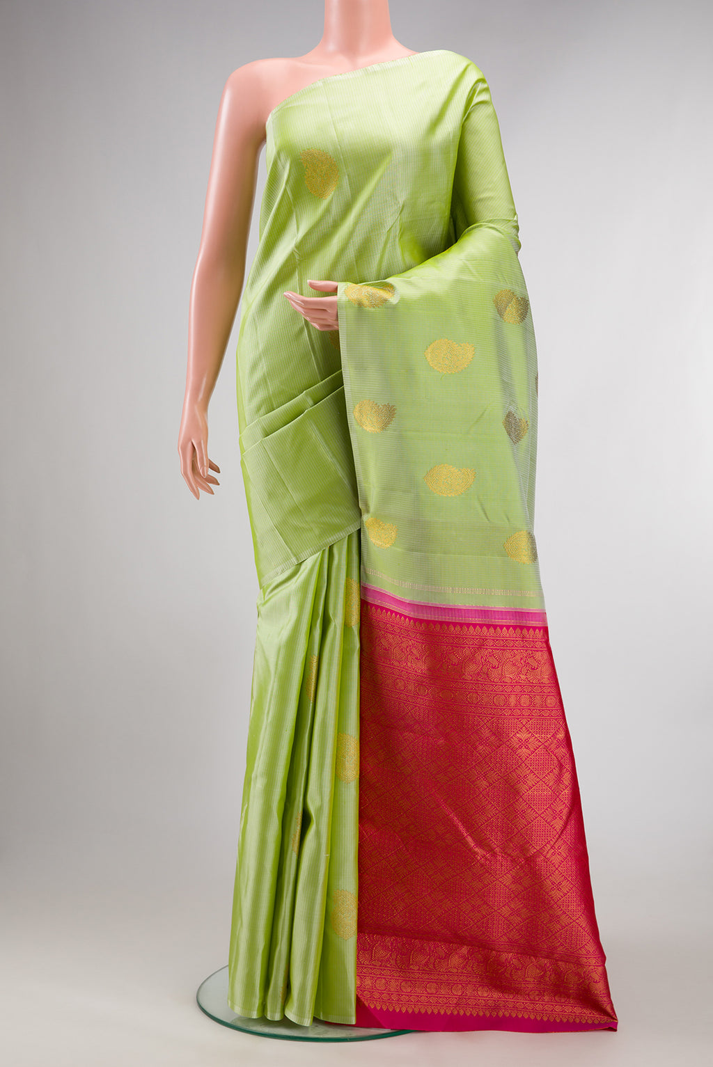 Pure Silk Pista Green Kanchipuram Saree with Zari Butta on the body and Without Border.  displayed on a mannequin