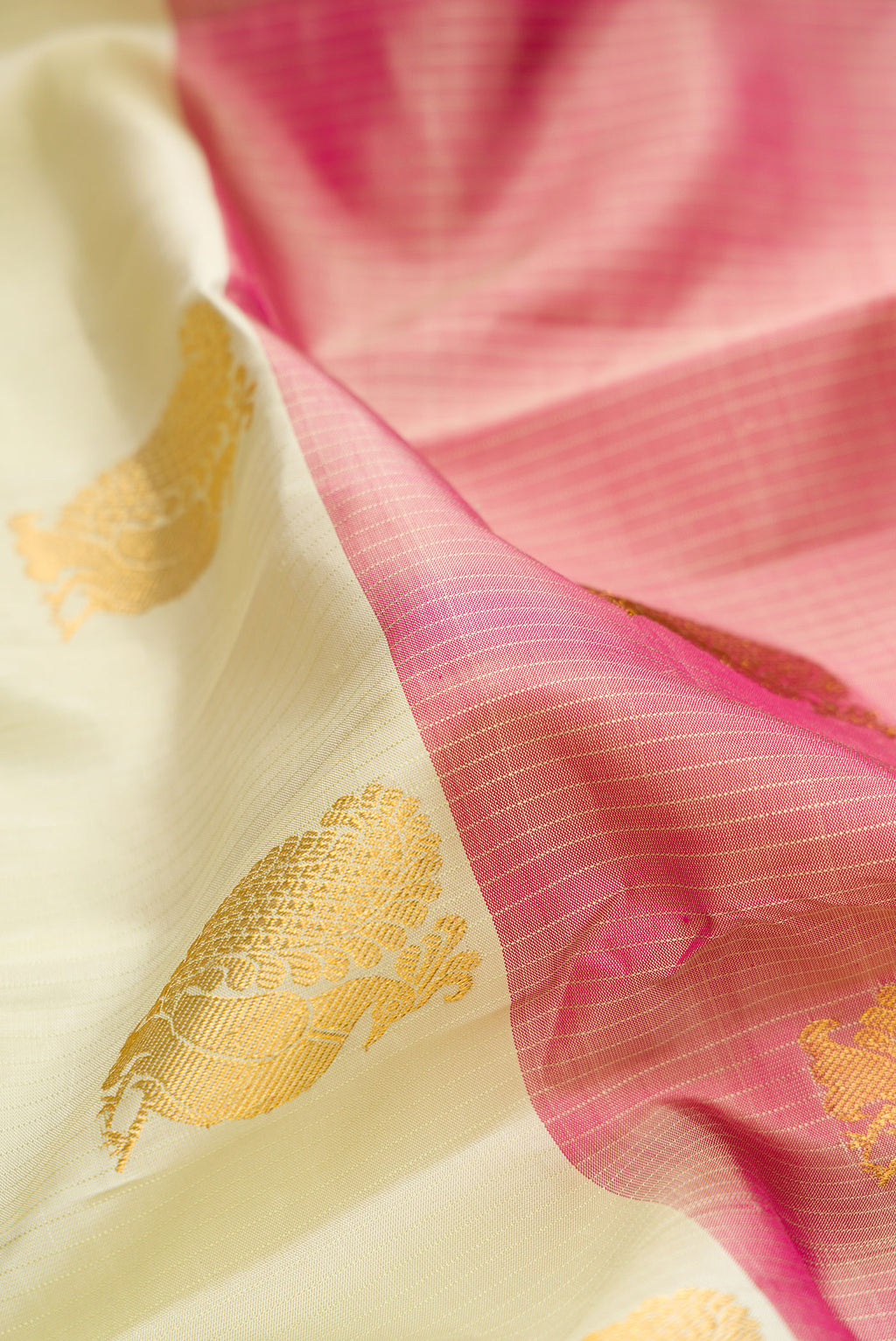 Close up of Pure Silk Pista Green and Peach Color Kanchipuram Saree with Half And Half on the body and Without Border.  displaying folds