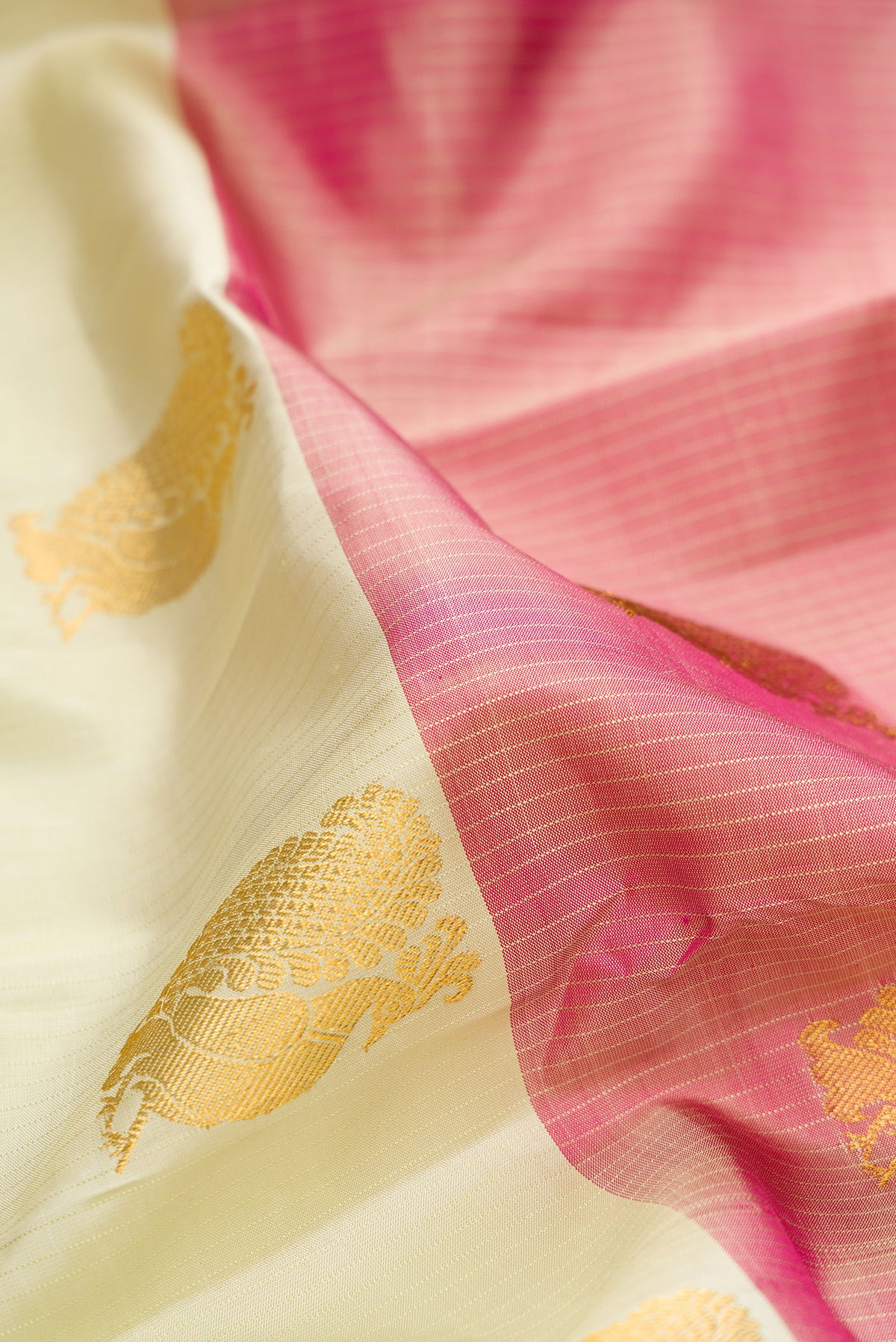 Close up of Pure Silk Pista Green and Peach Color Kanchipuram Saree with Half And Half on the body and Without Border.  displaying folds