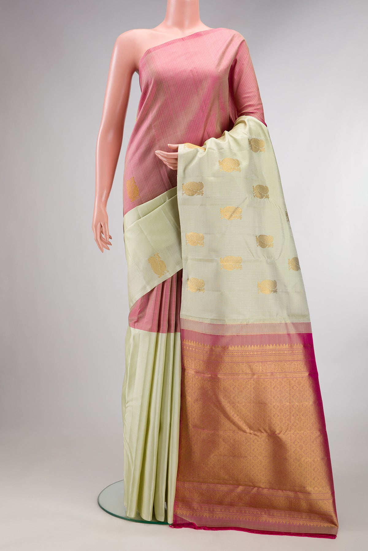 Pure Silk Pista Green and Peach Color Kanchipuram Saree with Half And Half on the body and Without Border.  displayed on a mannequin
