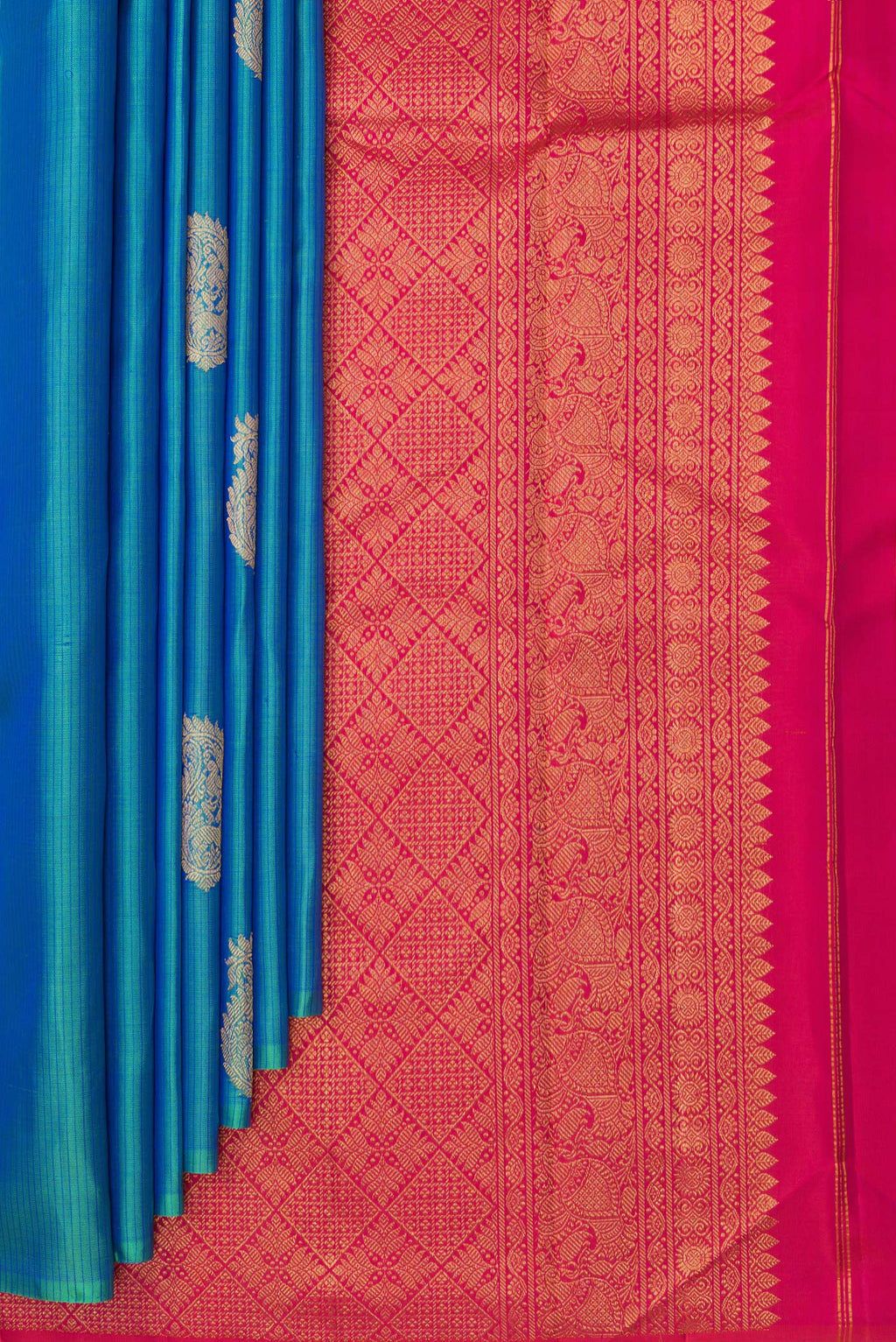 Pleats and pallu of Pure Silk Peacock Blue Dual Tone Kanchipuram Saree with Zari Butta on the body and Without Border. 