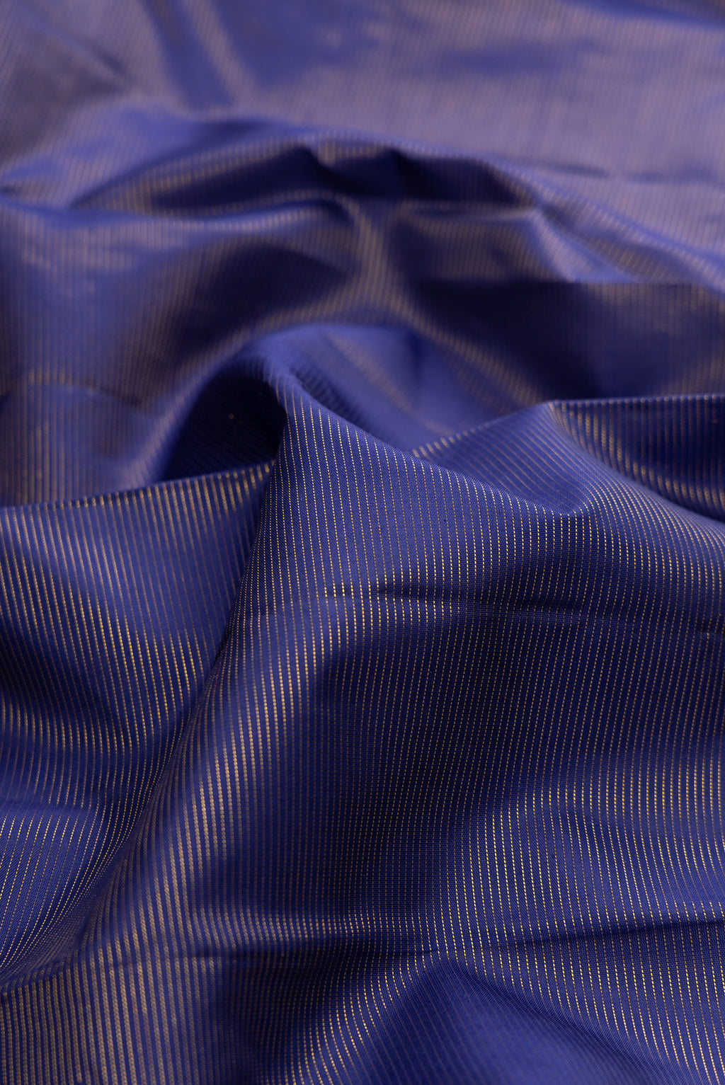 Close up of Pure Silk Royal Blue Kanchipuram Saree with Stripes on the body and Fancy Border.  displaying folds