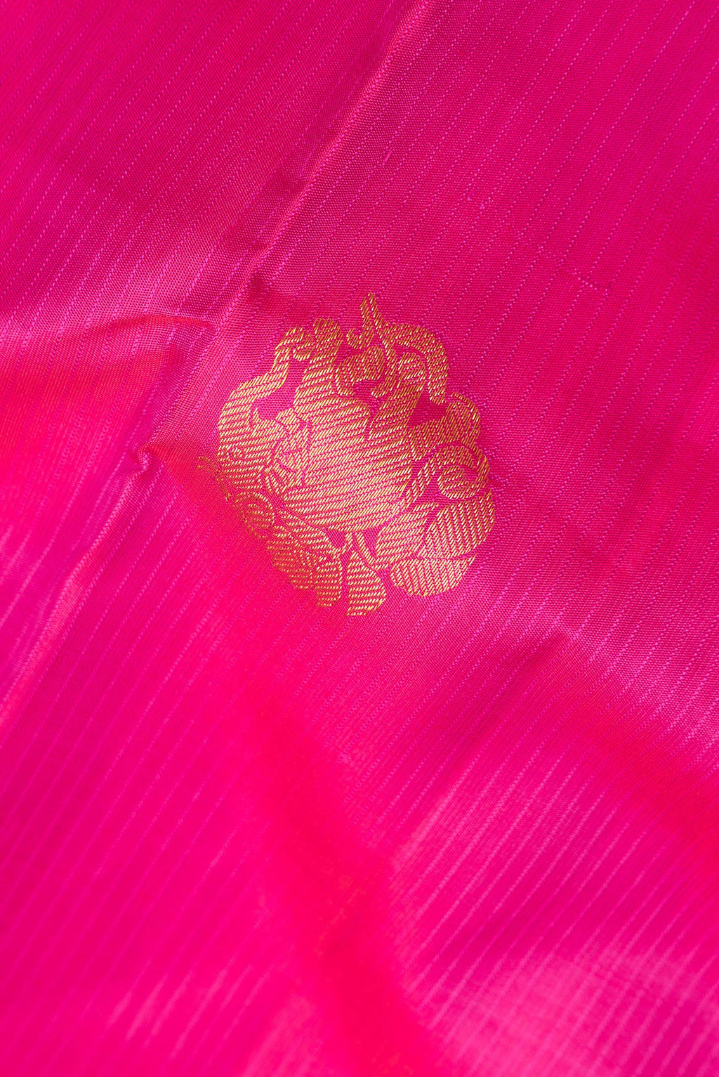 Close up of Pure Silk Dark Pink Kanchipuram Saree with Zari Butta on the body and Without Border.  displaying folds