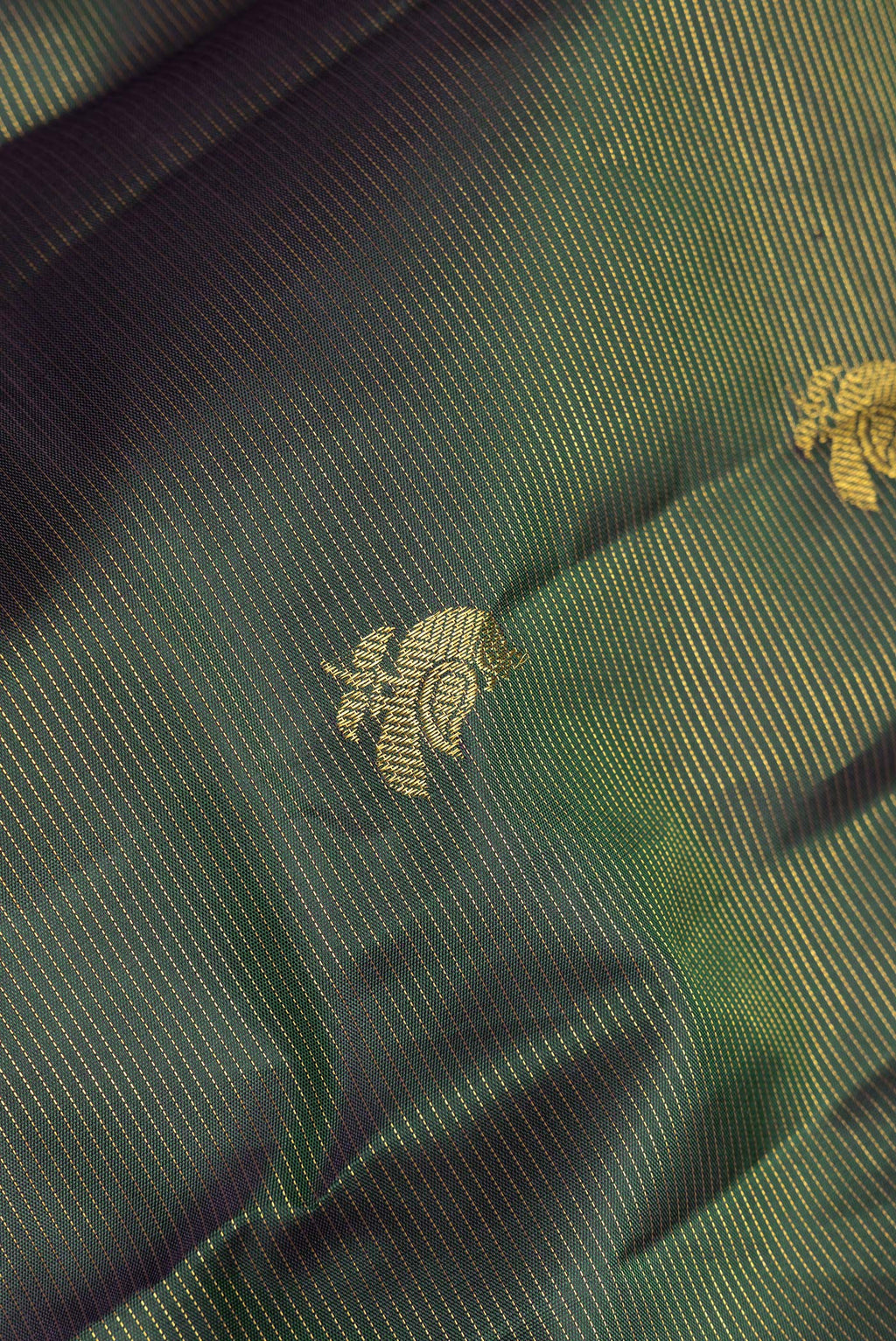 Close up of Pure Silk Bottle Green Kanchipuram Saree with Stripes on the body and Without Border.  displaying folds