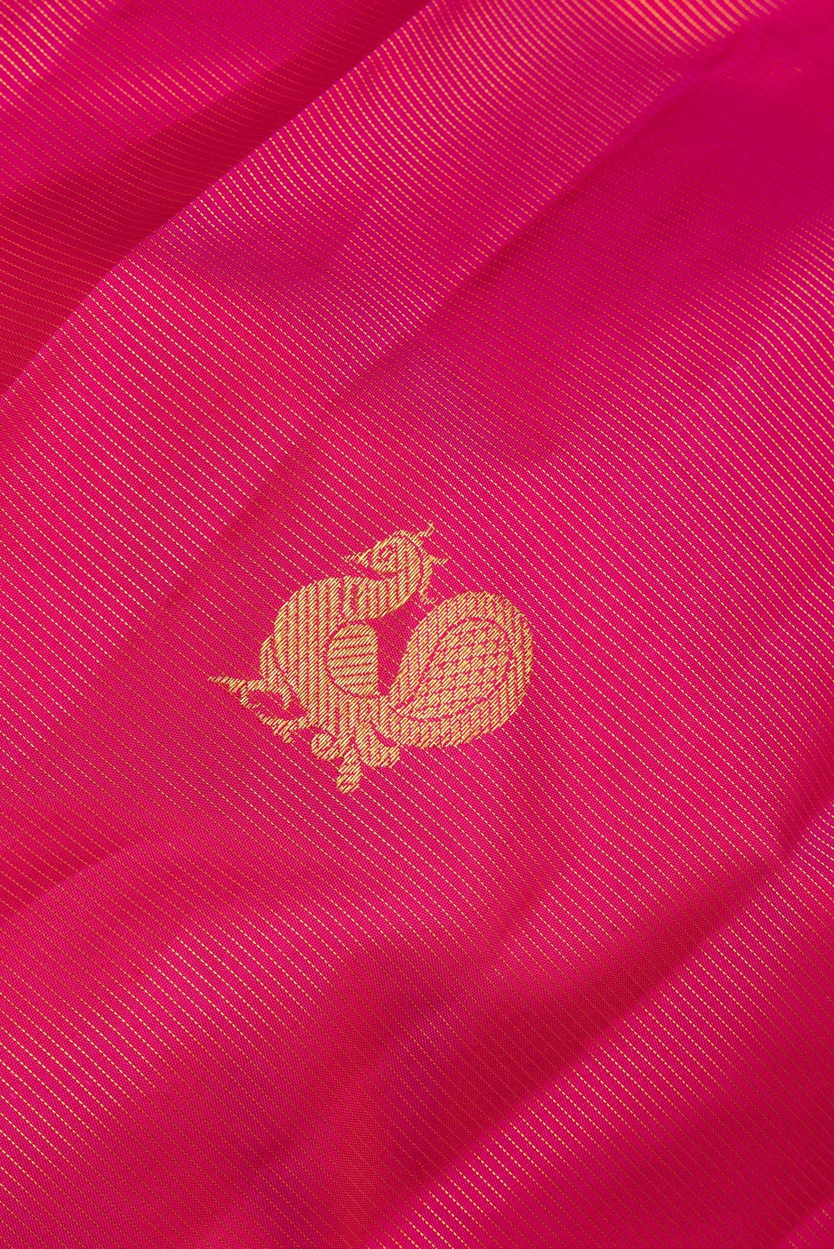 Close up of Pure Silk Dark Pink Kanchipuram Saree with Zari Butta on the body and Zari Border.  displaying folds