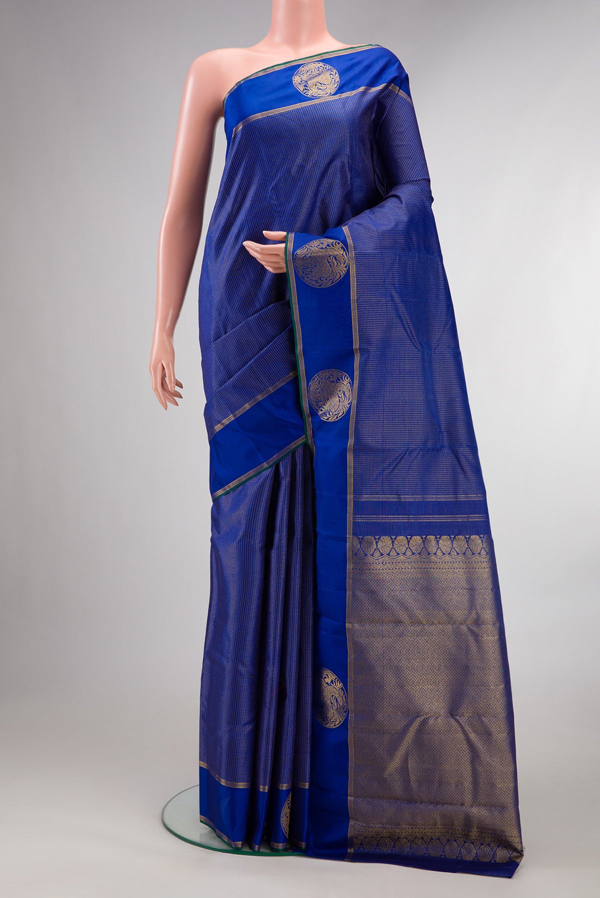 Pure Silk Royal Blue Kanchipuram Saree with Checked design on the body and Fancy Border.  displayed on a mannequin