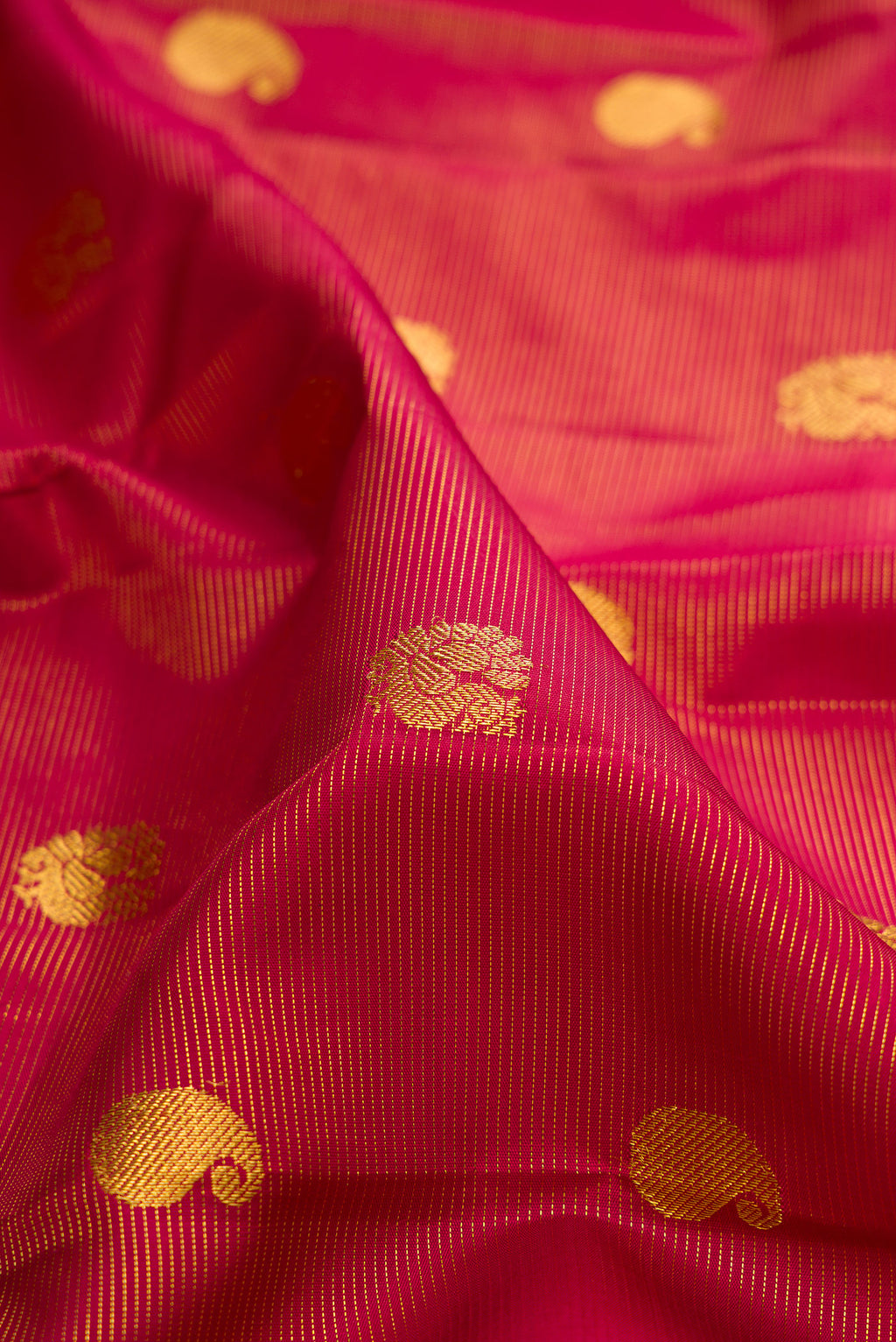Close up of Pure Silk Red Kanchipuram Saree with Stripes on the body and Zari Border.  displaying folds