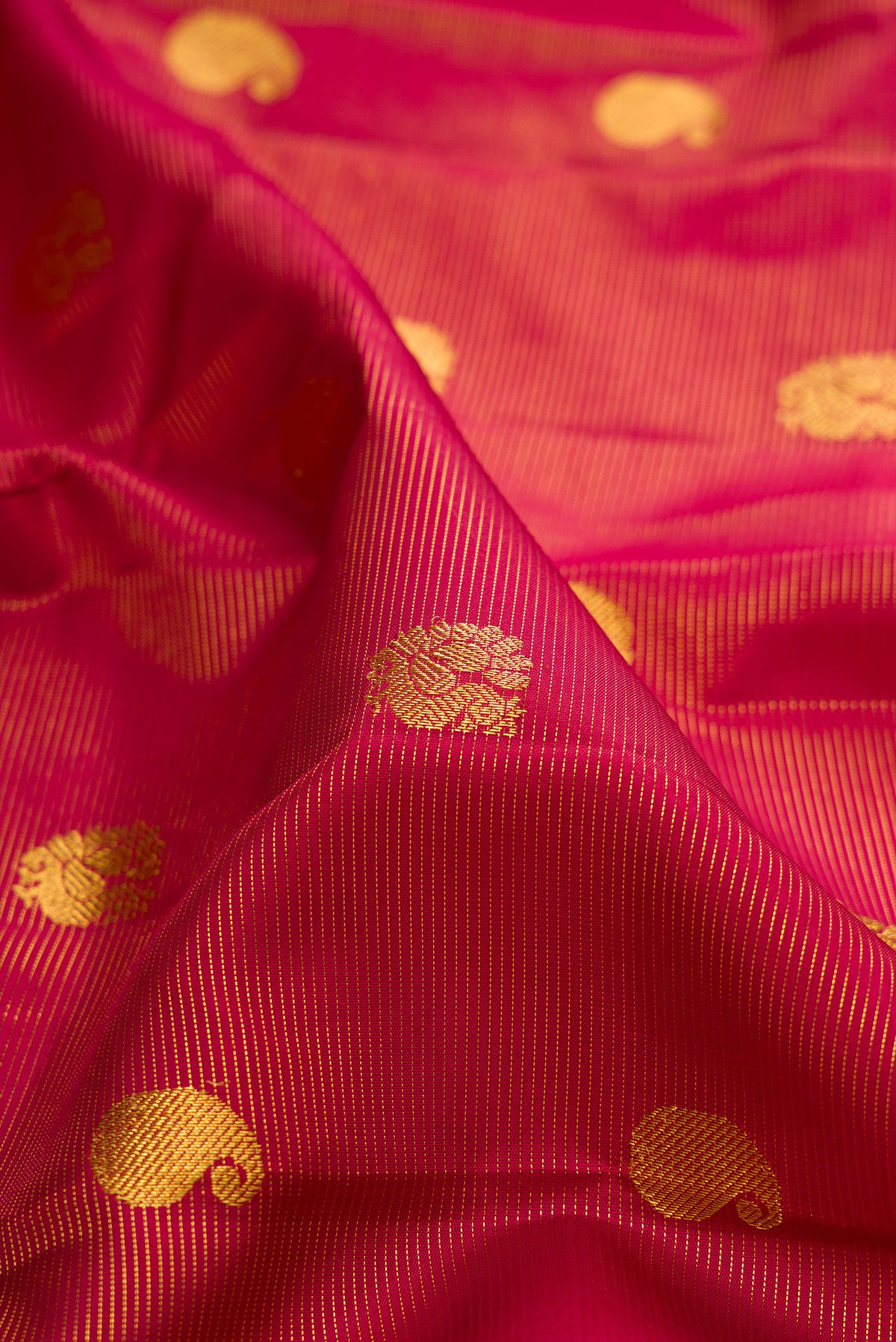 Close up of Pure Silk Red Kanchipuram Saree with Stripes on the body and Zari Border.  displaying folds
