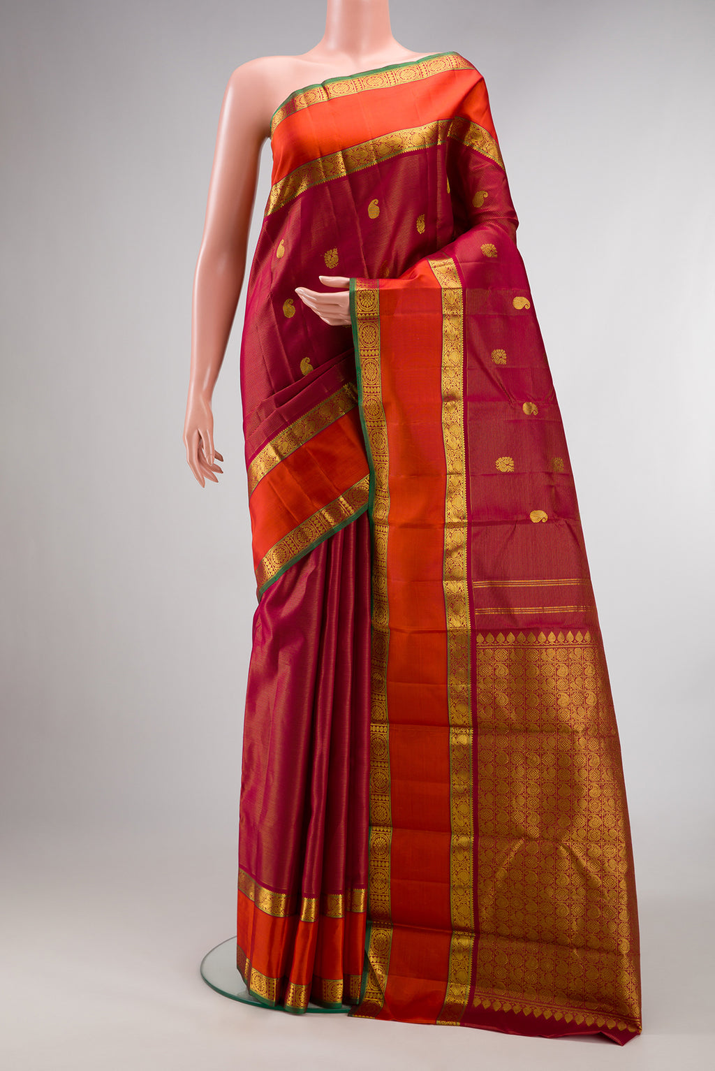 Pure Silk Red Kanchipuram Saree with Stripes on the body and Zari Border.  displayed on a mannequin