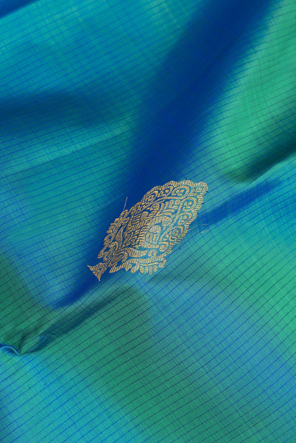 Close up of Pure Silk Peacock Blue Kanjivaram Saree with Stripes on the body and Zari Border.  displaying folds