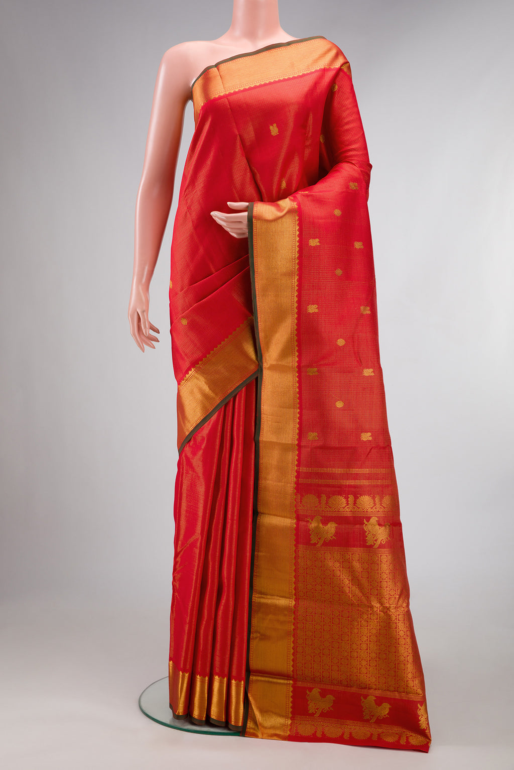 Pure Silk Brick Orange Dual Tone Kanjivaram Saree with Zari Butta on the body and Zari Border.  displayed on a mannequin