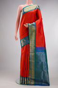Pure Silk Brick Orange Kanjivaram Saree with Plain Body and Zari Border.  displayed on a mannequin
