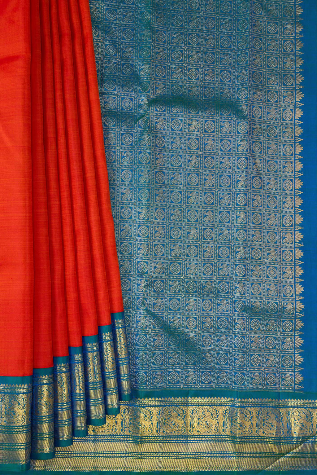 Pleats and pallu of Pure Silk Brick Orange Kanjivaram Saree with Plain Body and Zari Border. 